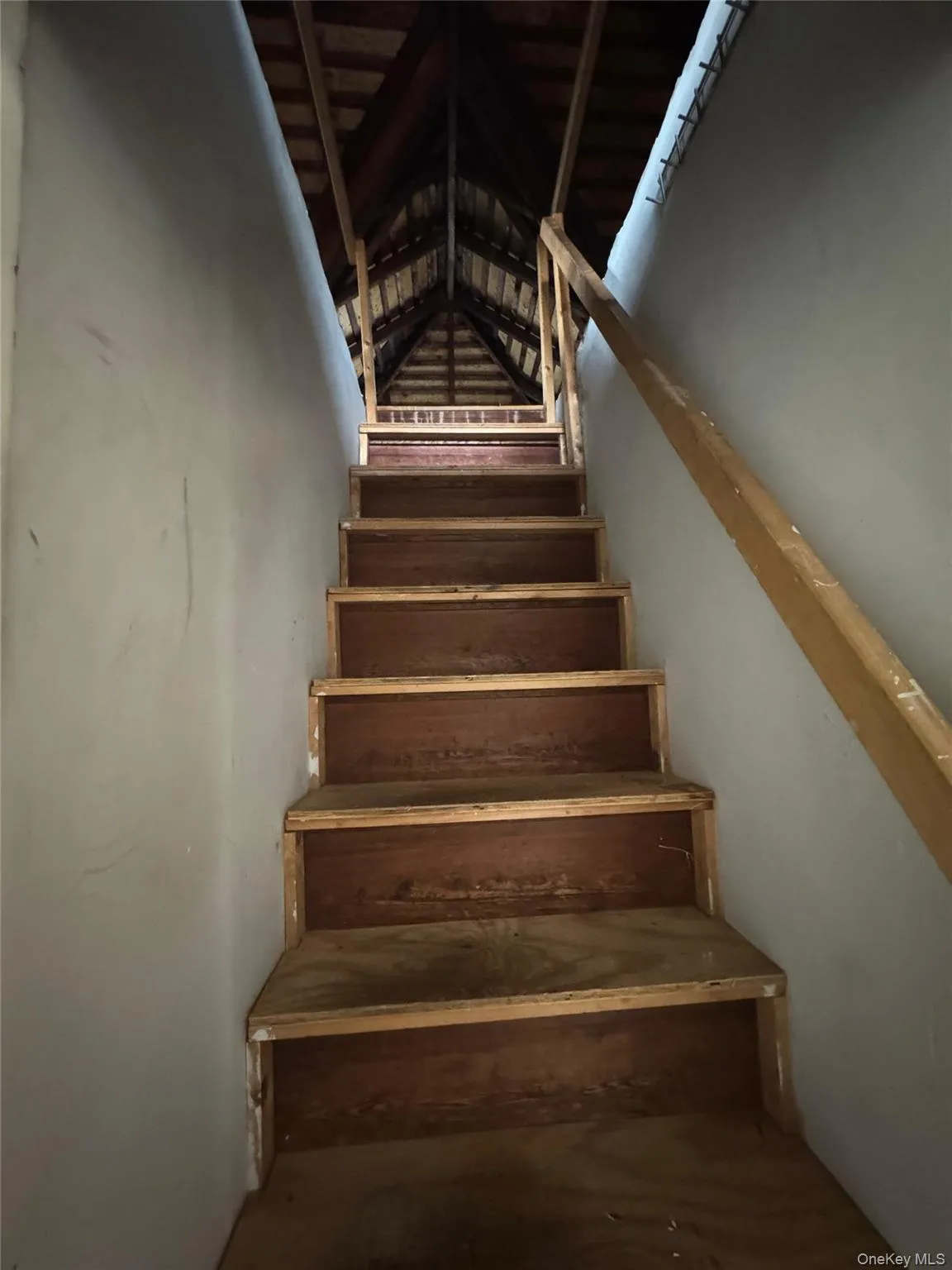 Staircase featuring lofted ceiling Staircase featuring lofted ceiling