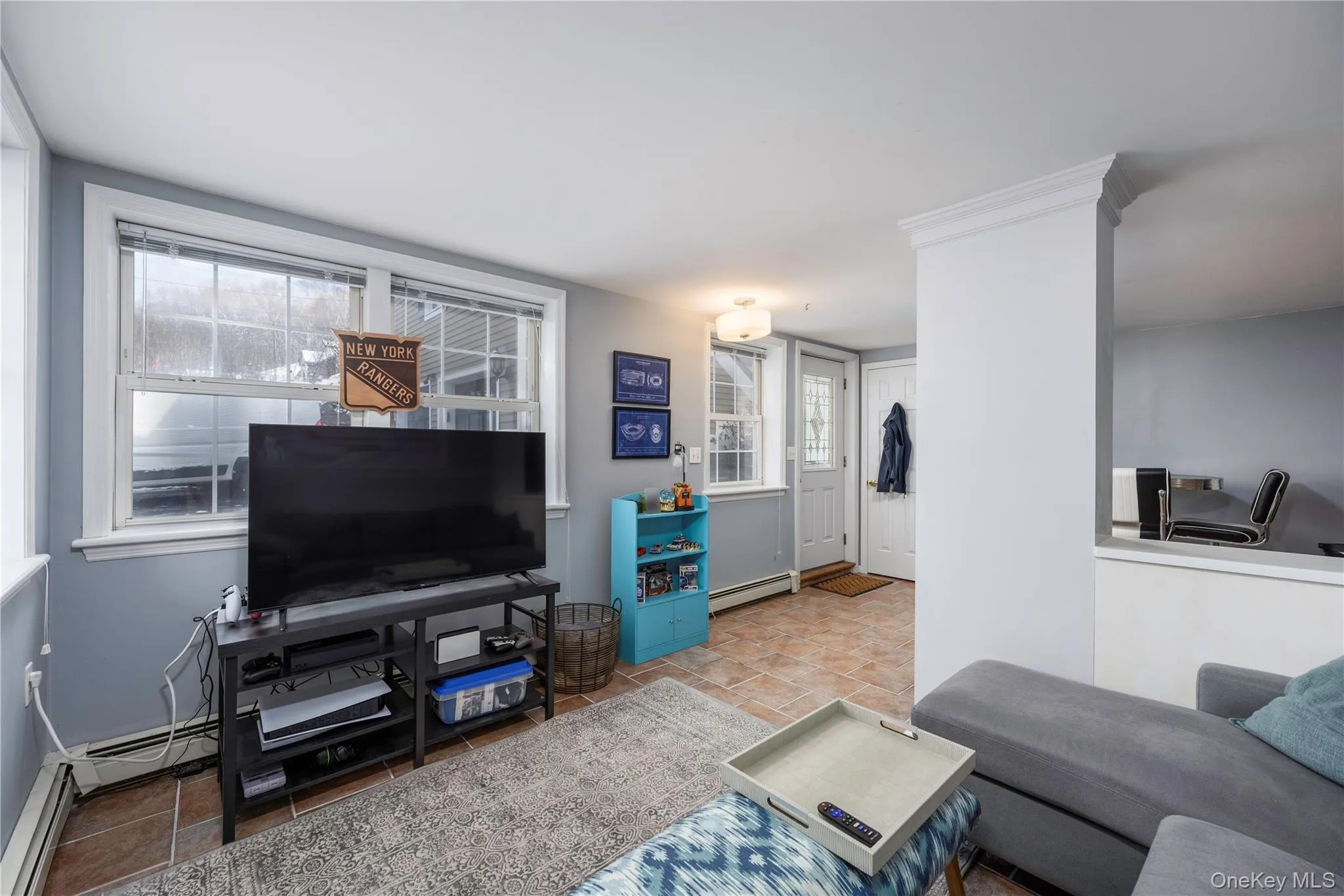 Living area featuring a baseboard heating unit Living area featuring a baseboard heating unit