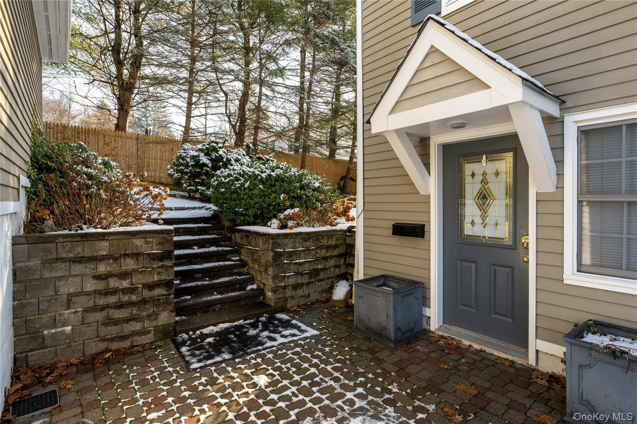 Snow covered property entrance featuring a patio Snow covered property entrance featuring a patio