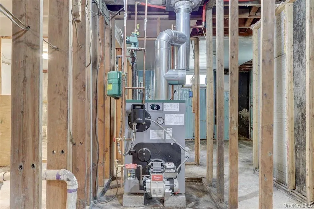 Utility room featuring a heating unit Utility room featuring a heating unit