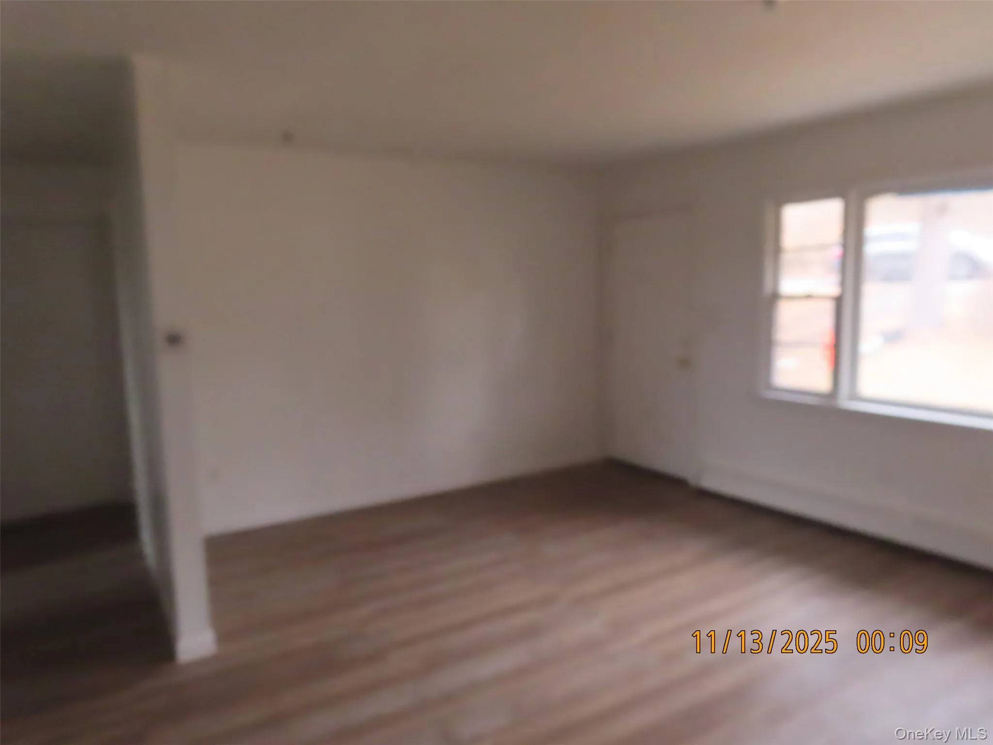 Empty room featuring dark wood-style flooring Empty room featuring dark wood-style flooring