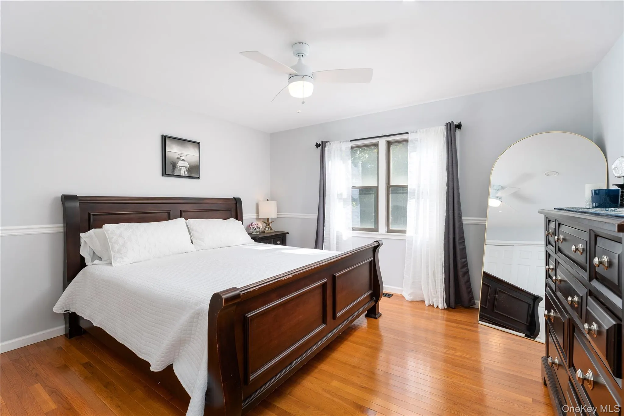 Bedroom featuring light wood-type flooring and a ceiling fan Bedroom featuring light wood-type flooring and a ceiling fan