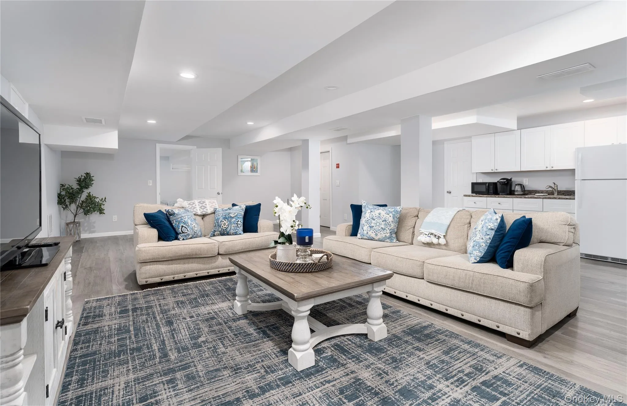 Living room featuring dark wood-style flooring and recessed lighting Living room featuring dark wood-style flooring and recessed lighting