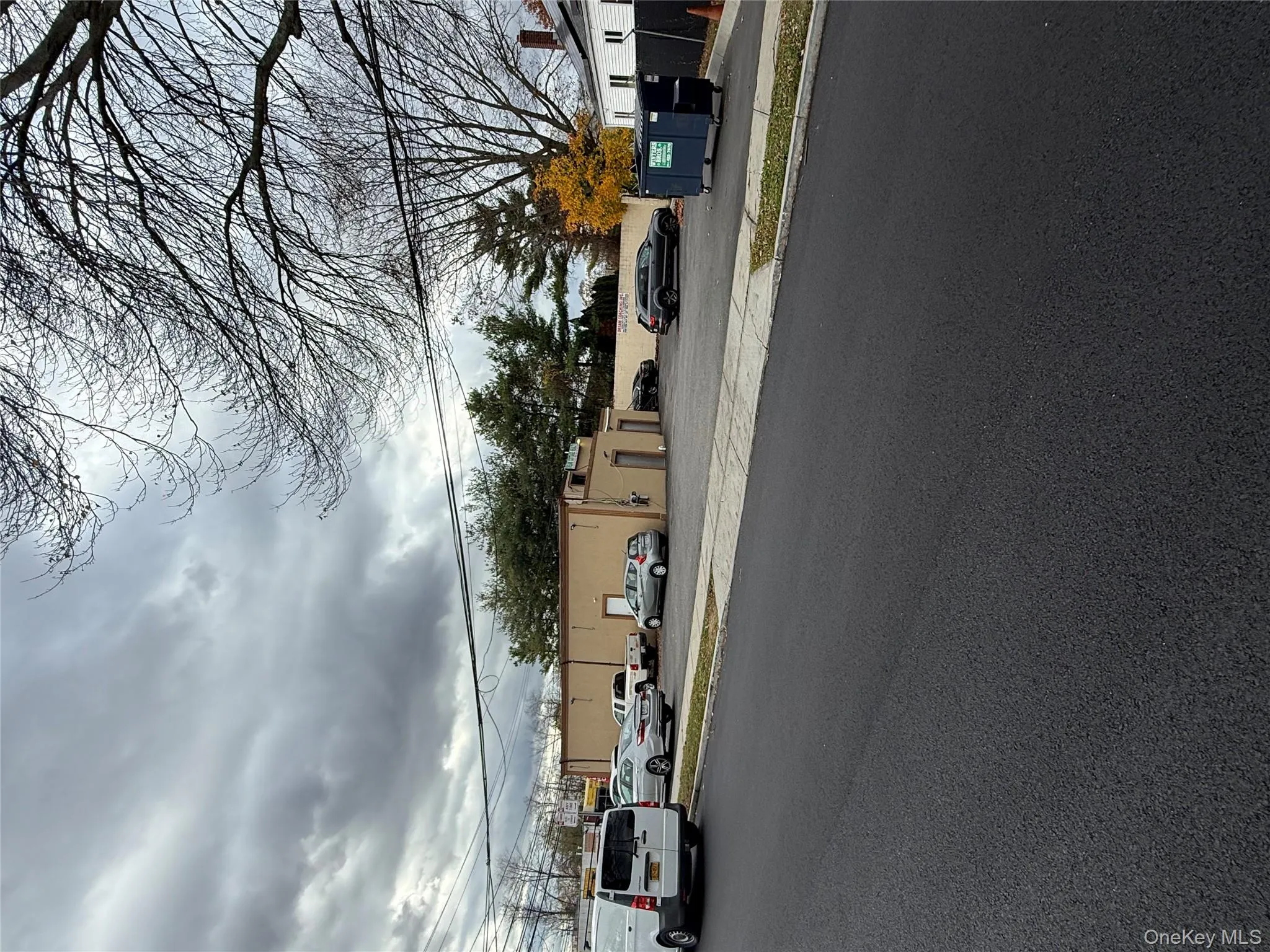 View of asphalt road featuring curbs and sidewalks View of asphalt road featuring curbs and sidewalks