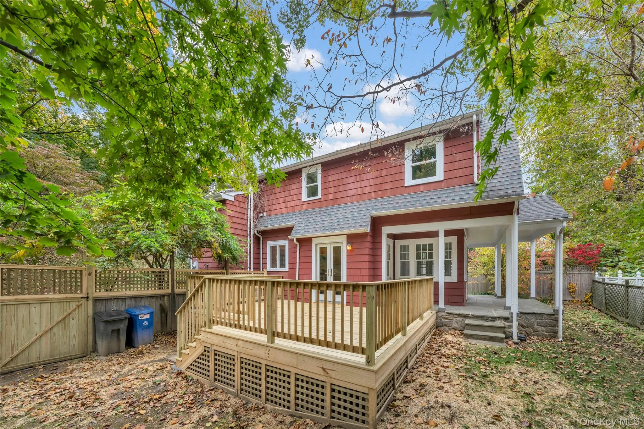 Back of house featuring roof with shingles, a fenced backyard, a gate, and french doors Back of house featuring roof with shingles, a fenced backyard, a gate, and french doors
