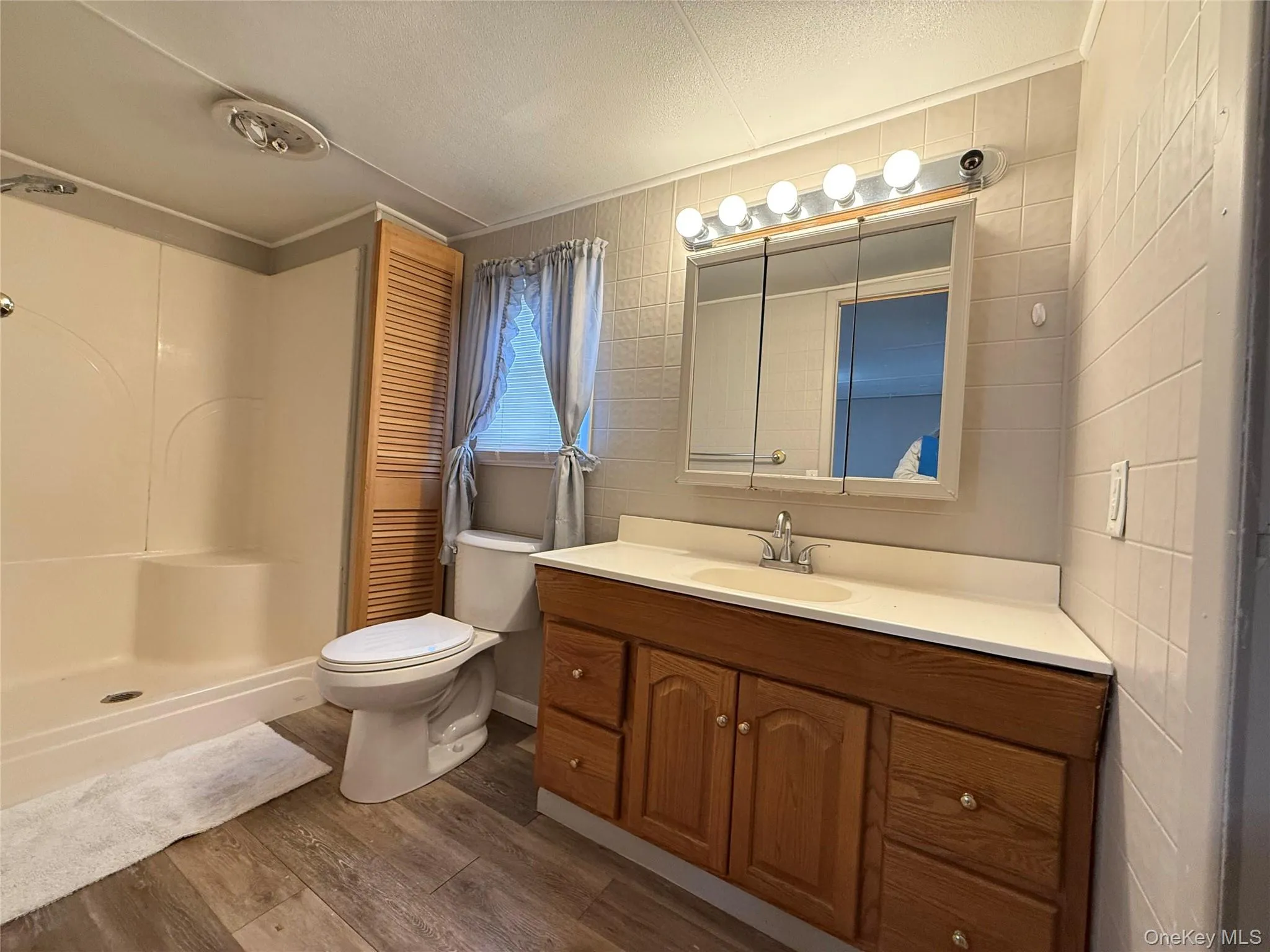 Full bath with vanity, new flooring, and shower. Full bath with vanity, new flooring, and shower.