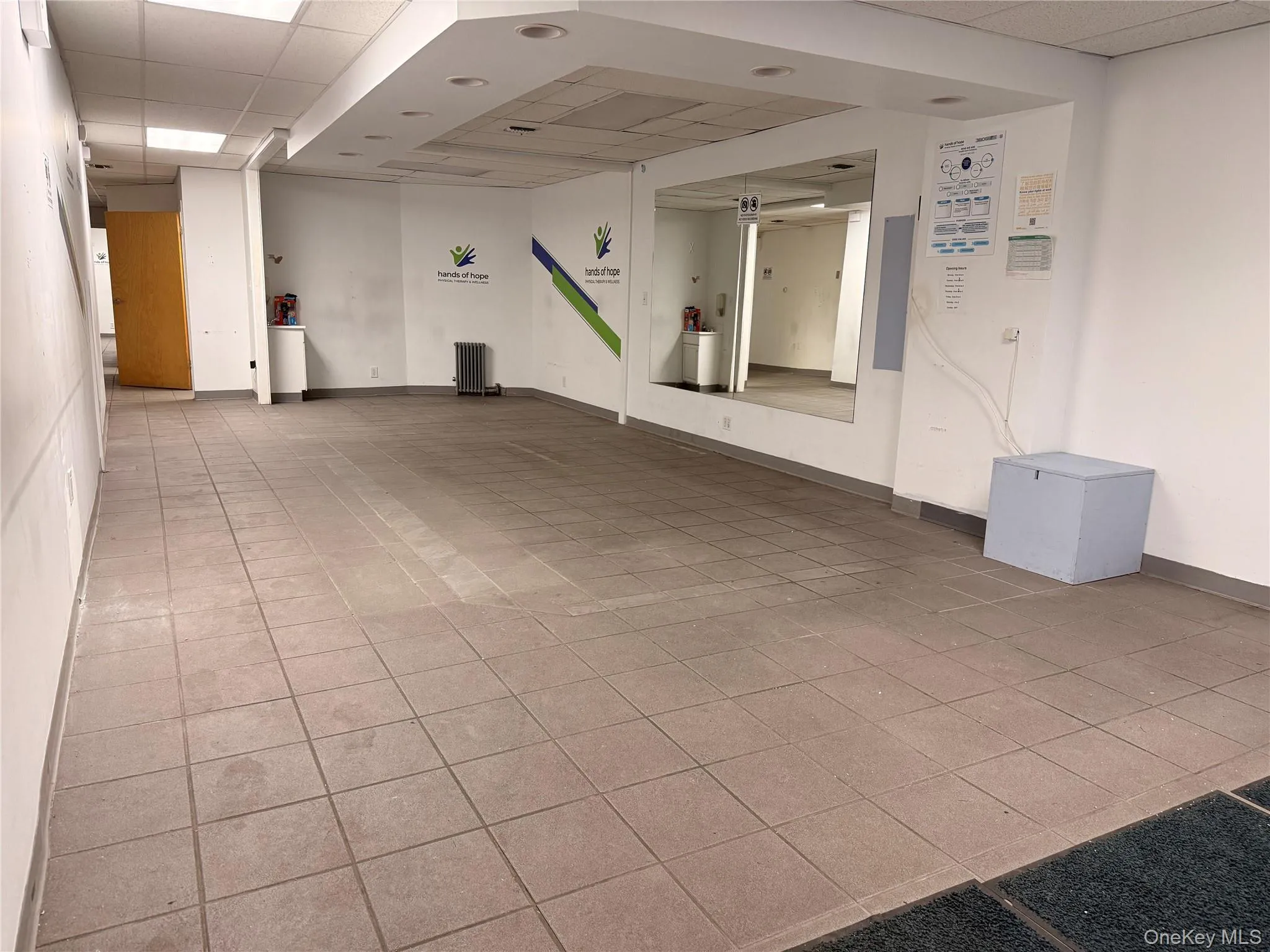 Spare room featuring a drop ceiling and light tile patterned flooring Spare room featuring a drop ceiling and light tile patterned flooring