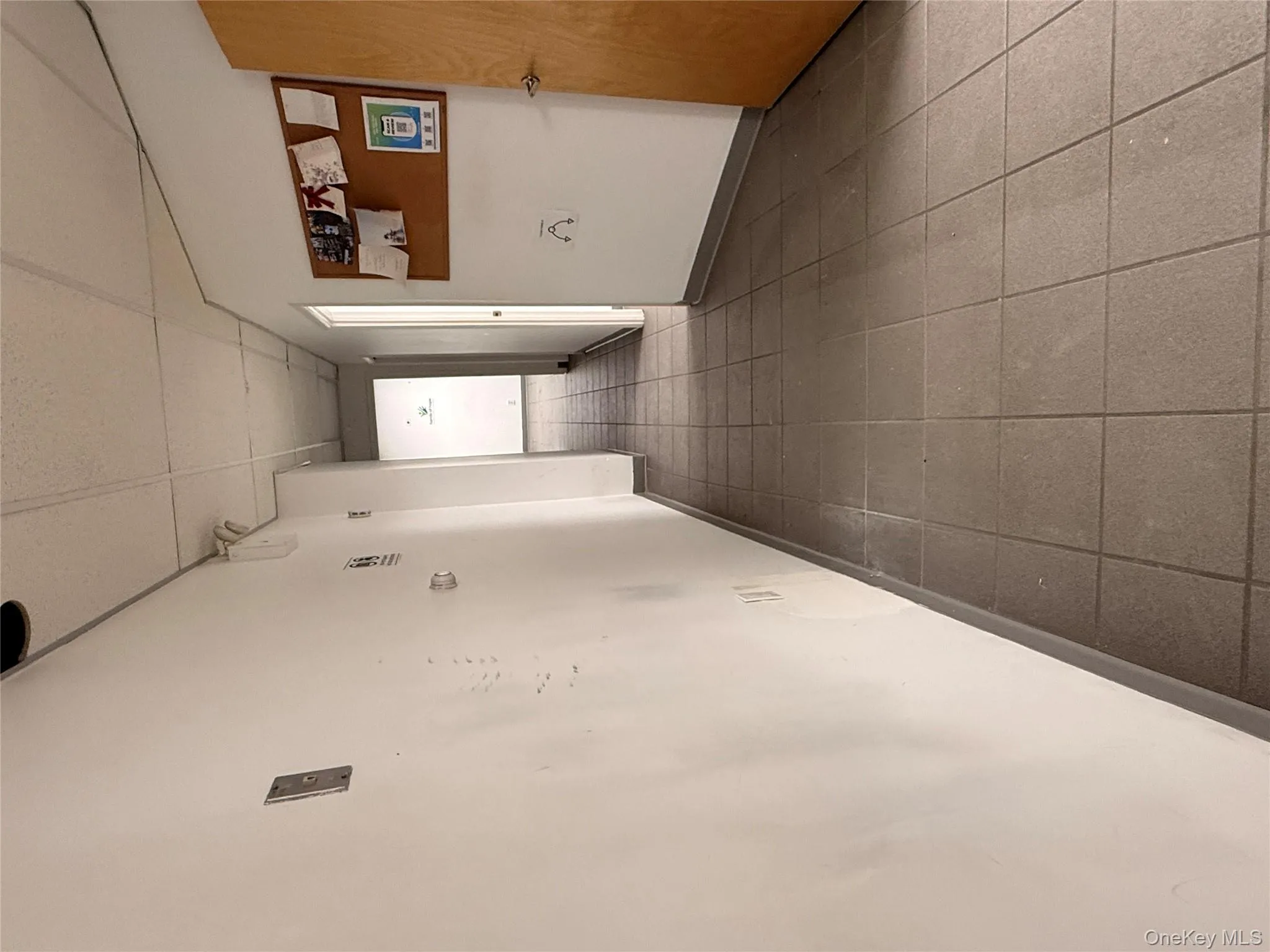 Hall with a paneled ceiling and tile patterned floors Hall with a paneled ceiling and tile patterned floors