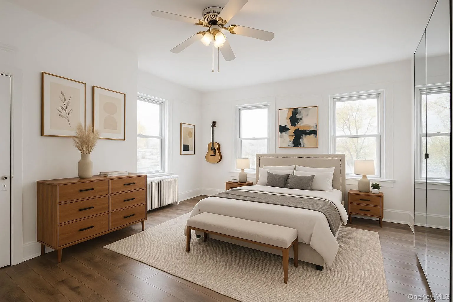 Bedroom with radiator, a ceiling fan, and dark wood-style floors Bedroom with radiator, a ceiling fan, and dark wood-style floors