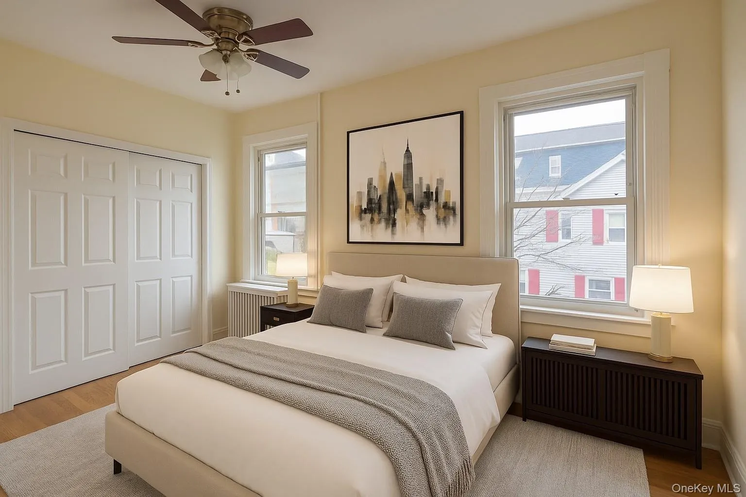 Bedroom with light wood-type flooring, radiator heating unit, a closet, and ceiling fan Bedroom with light wood-type flooring, radiator heating unit, a closet, and ceiling fan