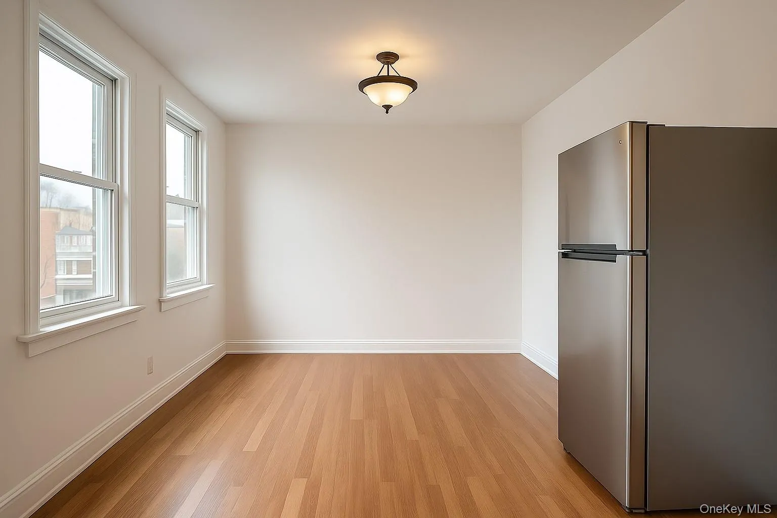 Unfurnished dining area featuring light wood-type flooring and baseboards Unfurnished dining area featuring light wood-type flooring and baseboards