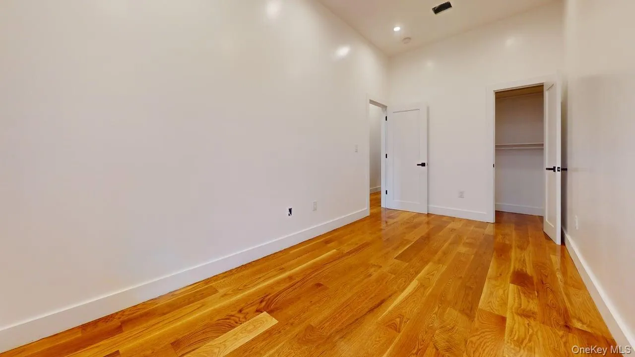 Unfurnished bedroom featuring light wood finished floors, a spacious closet, and recessed lighting Unfurnished bedroom featuring light wood finished floors, a spacious closet, and recessed lighting