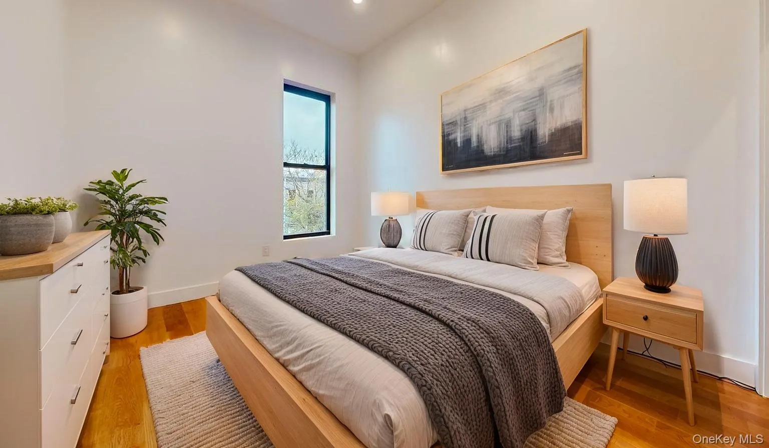 Bedroom featuring light wood-style flooring and recessed lighting Bedroom featuring light wood-style flooring and recessed lighting