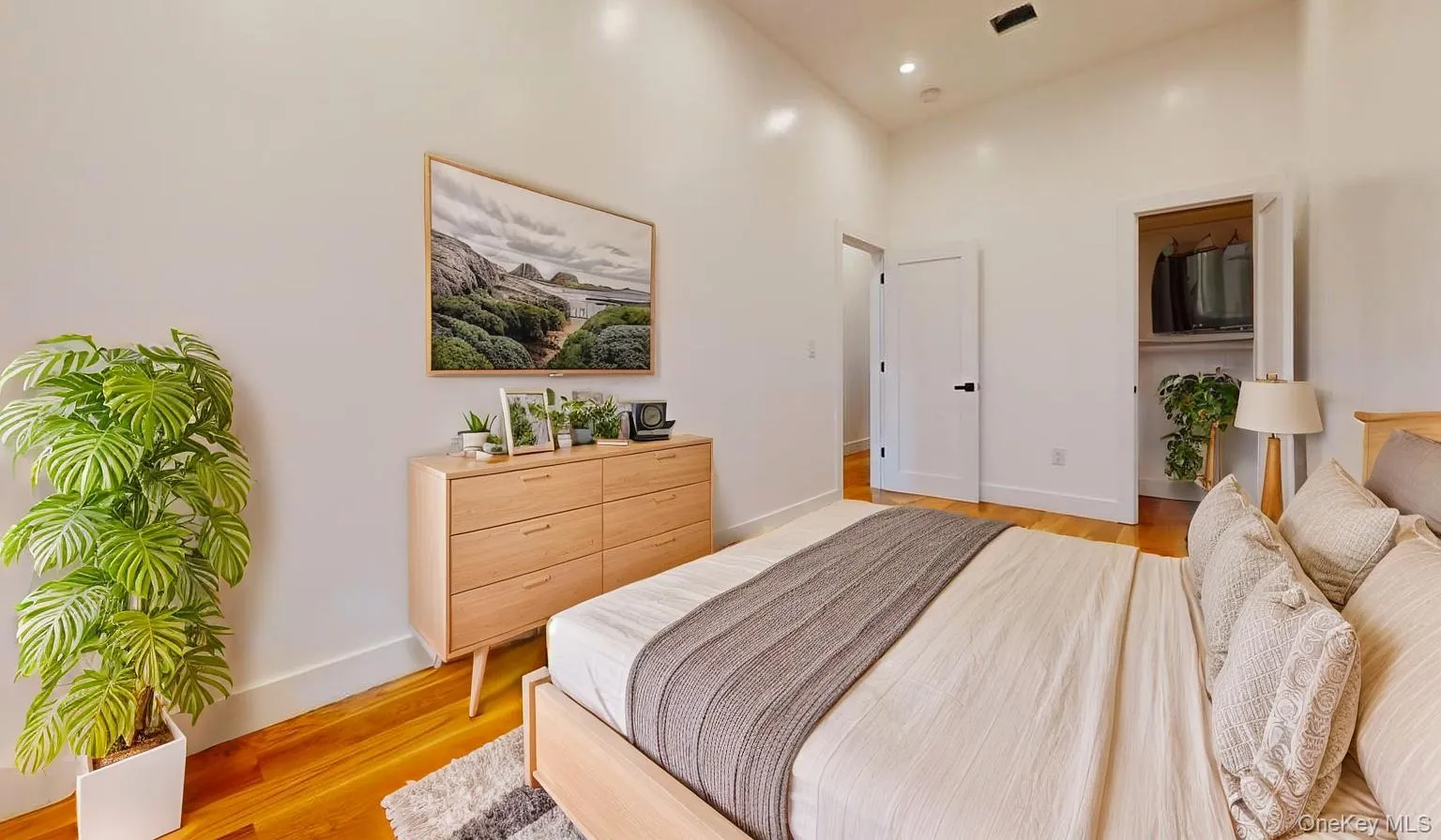 Bedroom featuring light wood-style floors and recessed lighting Bedroom featuring light wood-style floors and recessed lighting