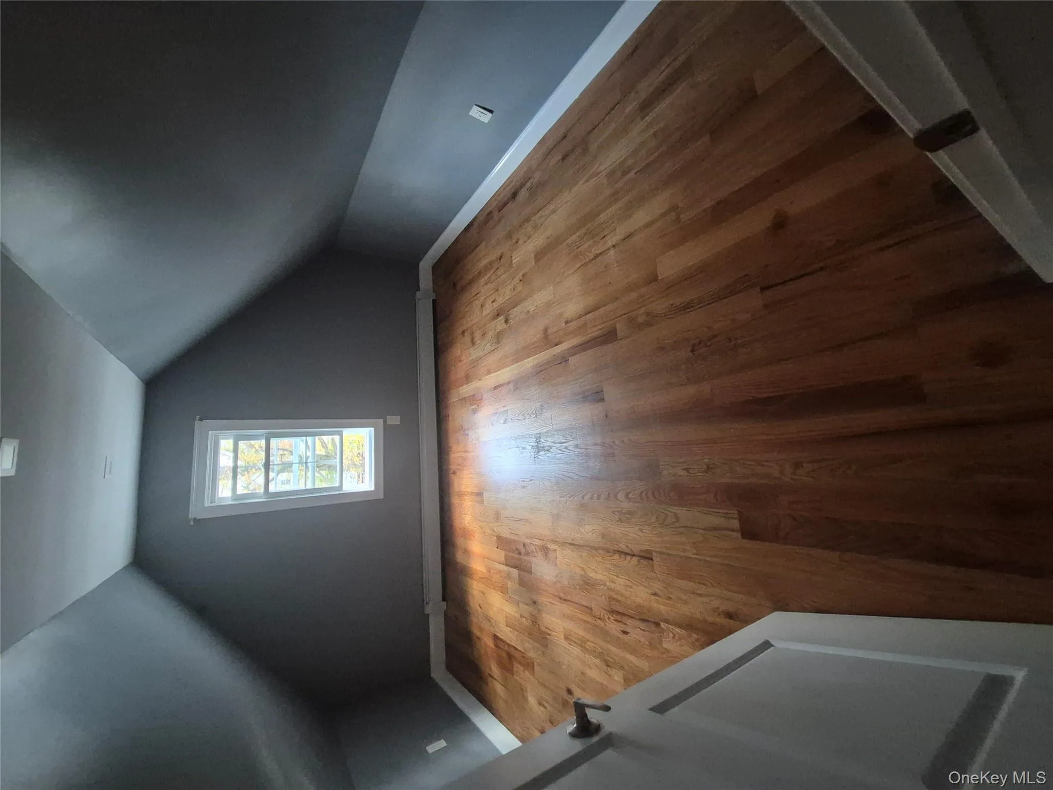 Bonus room featuring light wood-style flooring, lofted ceiling, and a baseboard heating unit Bonus room featuring light wood-style flooring, lofted ceiling, and a baseboard heating unit