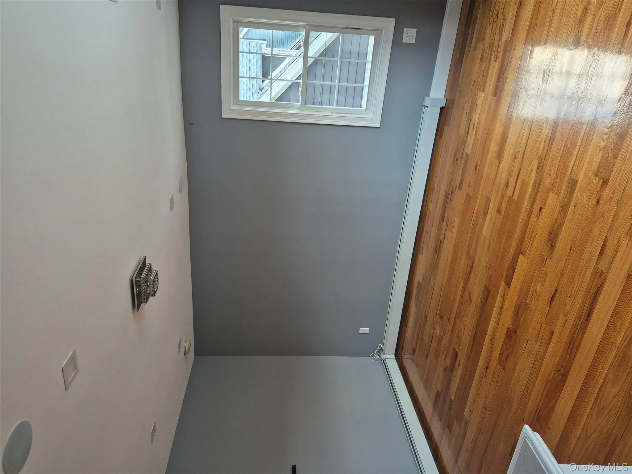 Empty room featuring light wood finished floors and a baseboard radiator Empty room featuring light wood finished floors and a baseboard radiator