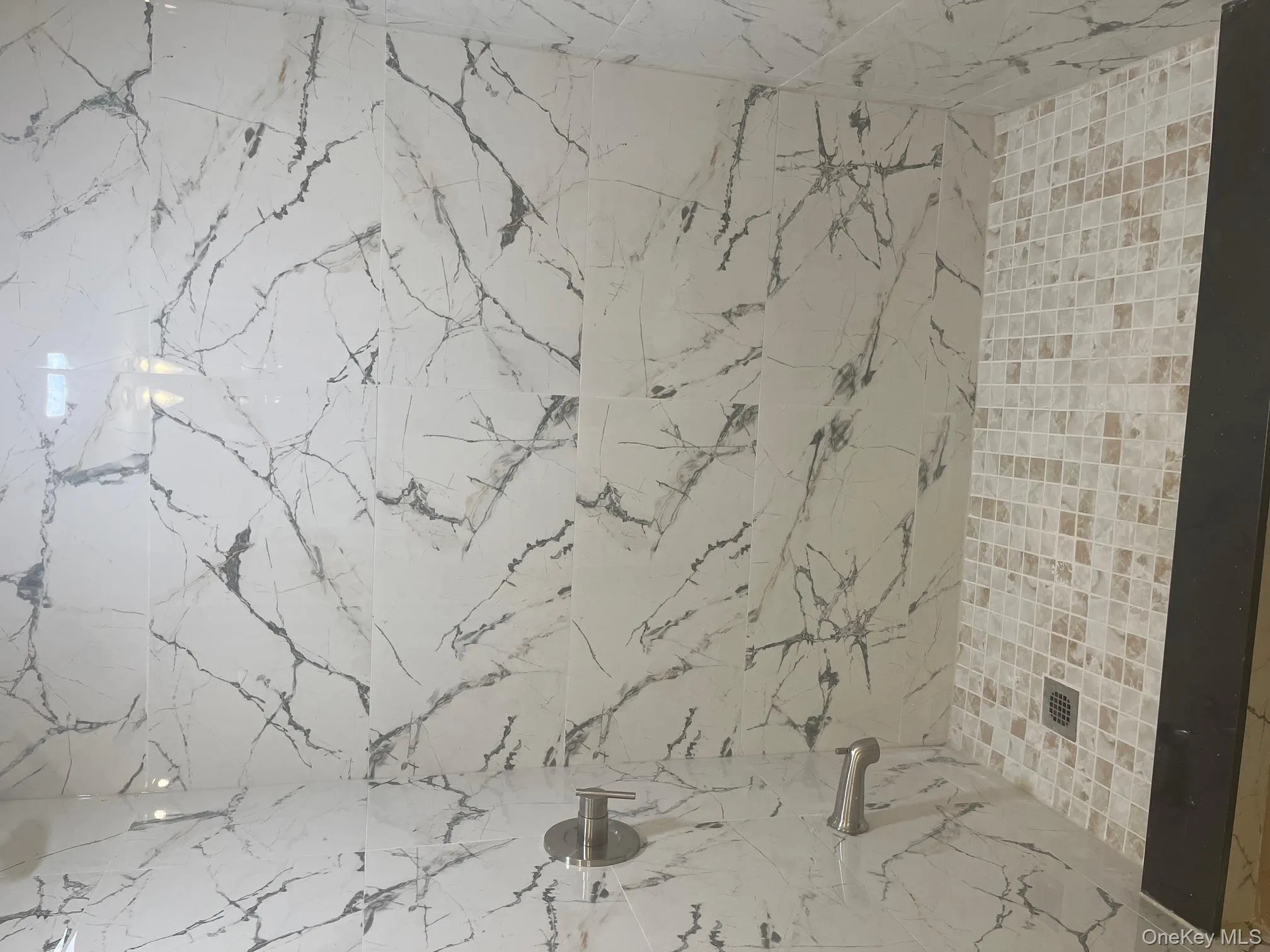 Bathroom with a marble finish shower Bathroom with a marble finish shower