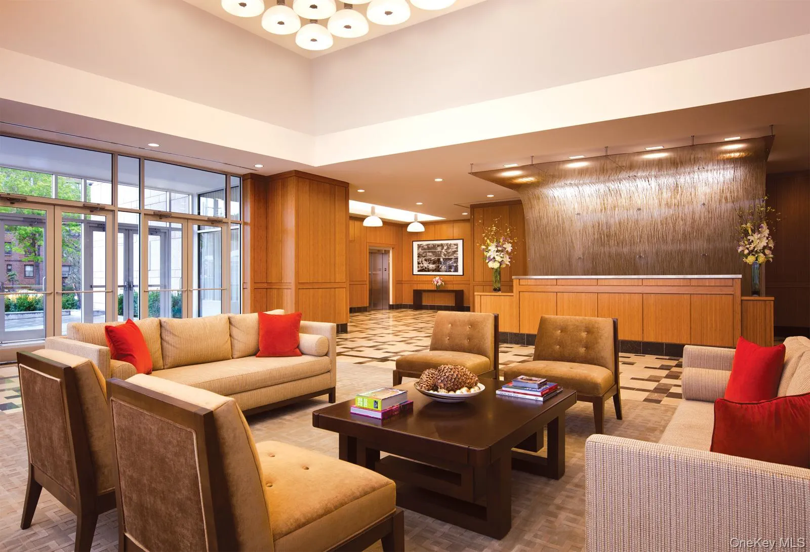 Building lobby with a towering ceiling, wood walls, and recessed lighting Building lobby with a towering ceiling, wood walls, and recessed lighting