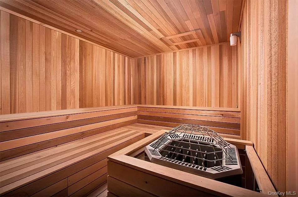 Relaxing sauna / steam room featuring wooden ceiling and wooden walls Relaxing sauna / steam room featuring wooden ceiling and wooden walls