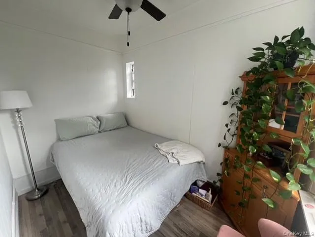 Bedroom featuring wood finished floors and ceiling fan Bedroom featuring wood finished floors and ceiling fan
