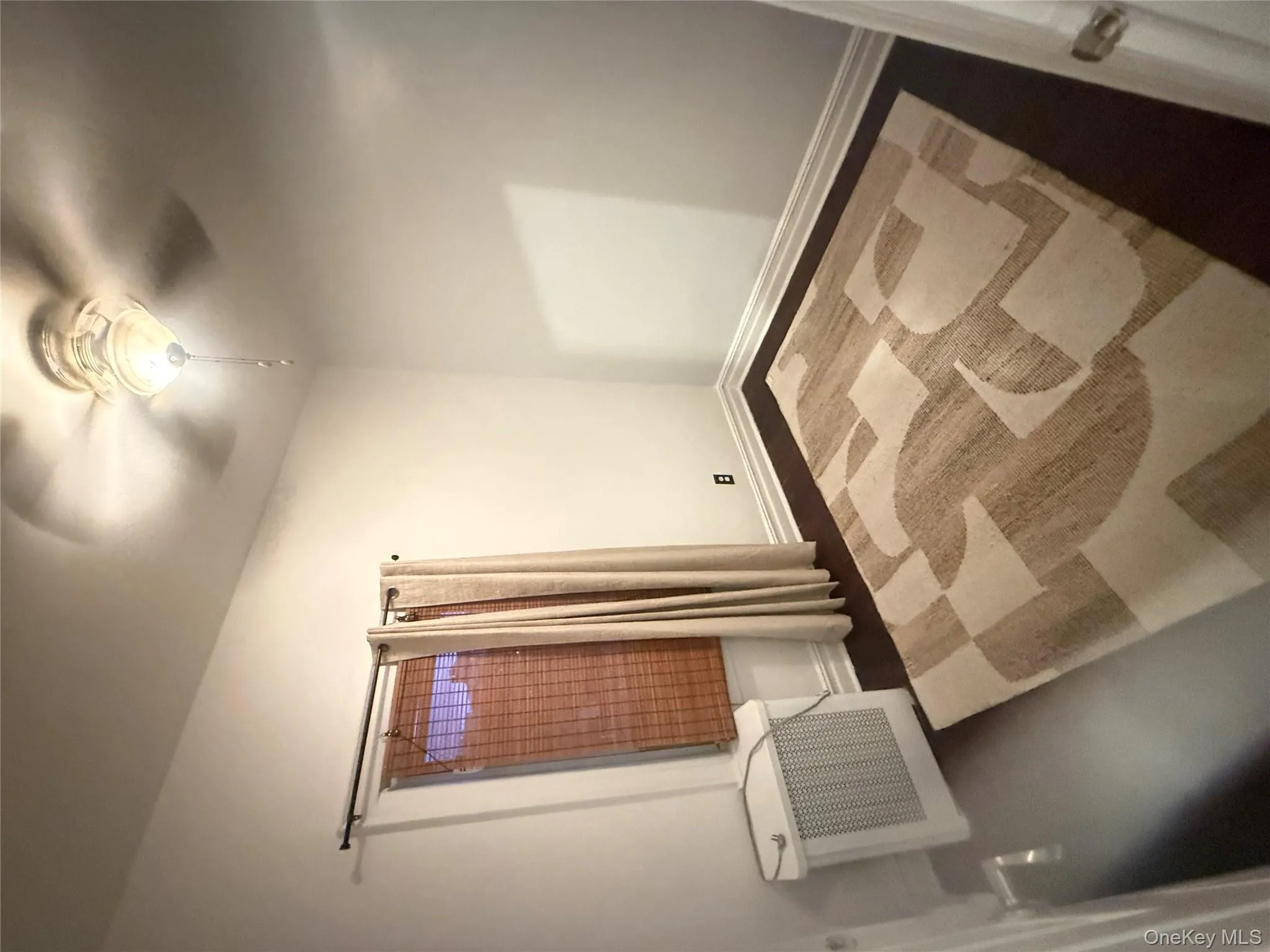 Spare room with radiator heating unit and a ceiling fan Spare room with radiator heating unit and a ceiling fan