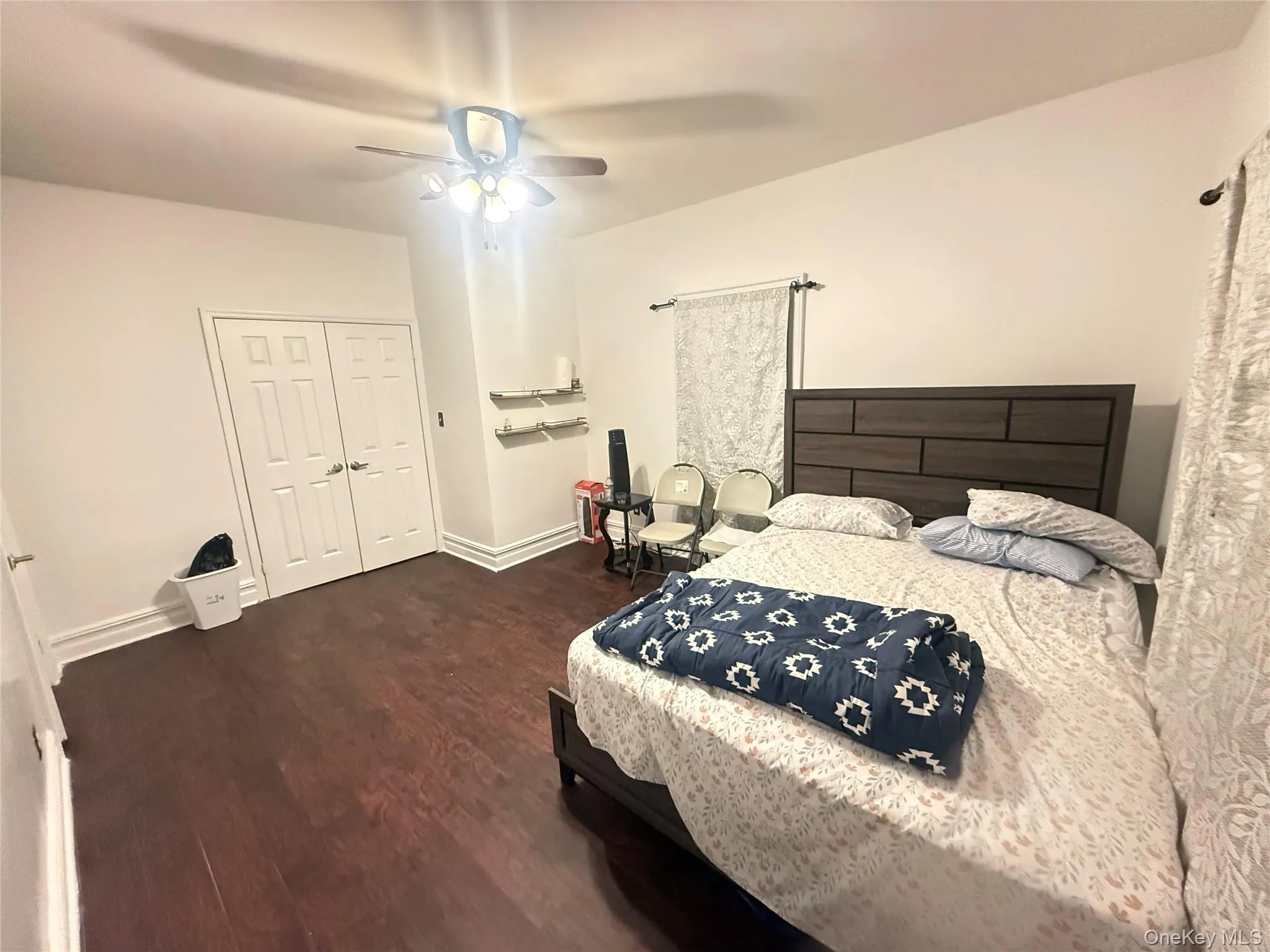 Bedroom with dark wood-style floors, a closet, and a ceiling fan Bedroom with dark wood-style floors, a closet, and a ceiling fan