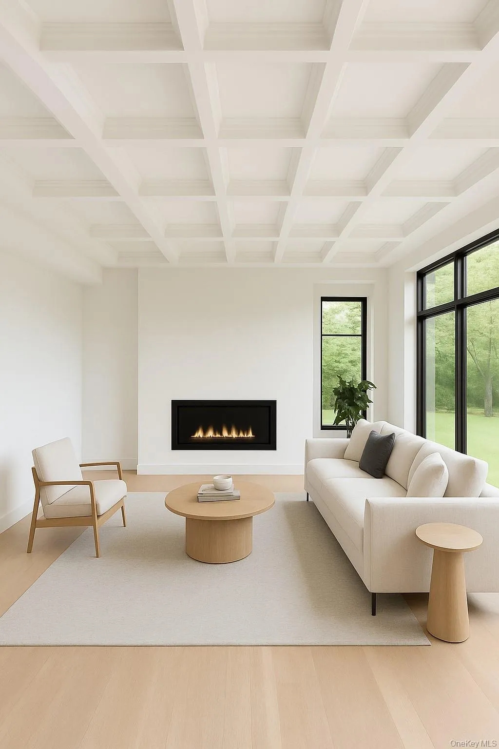 Living area featuring a warm lit fireplace, beamed ceiling, light wood-style floors, and coffered ceiling Living area featuring a warm lit fireplace, beamed ceiling, light wood-style floors, and coffered ceiling