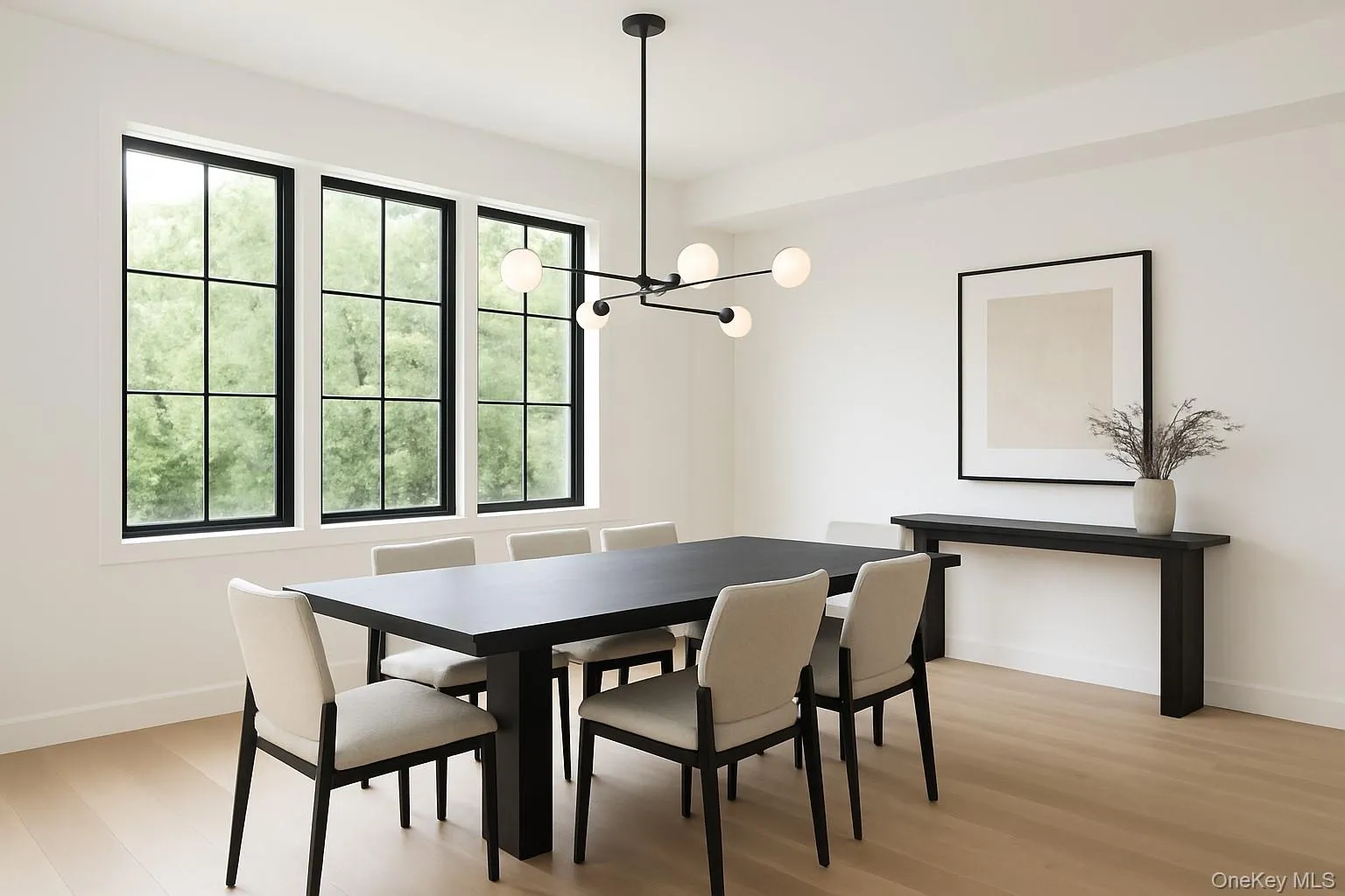 Dining area with light wood finished floors and a chandelier Dining area with light wood finished floors and a chandelier