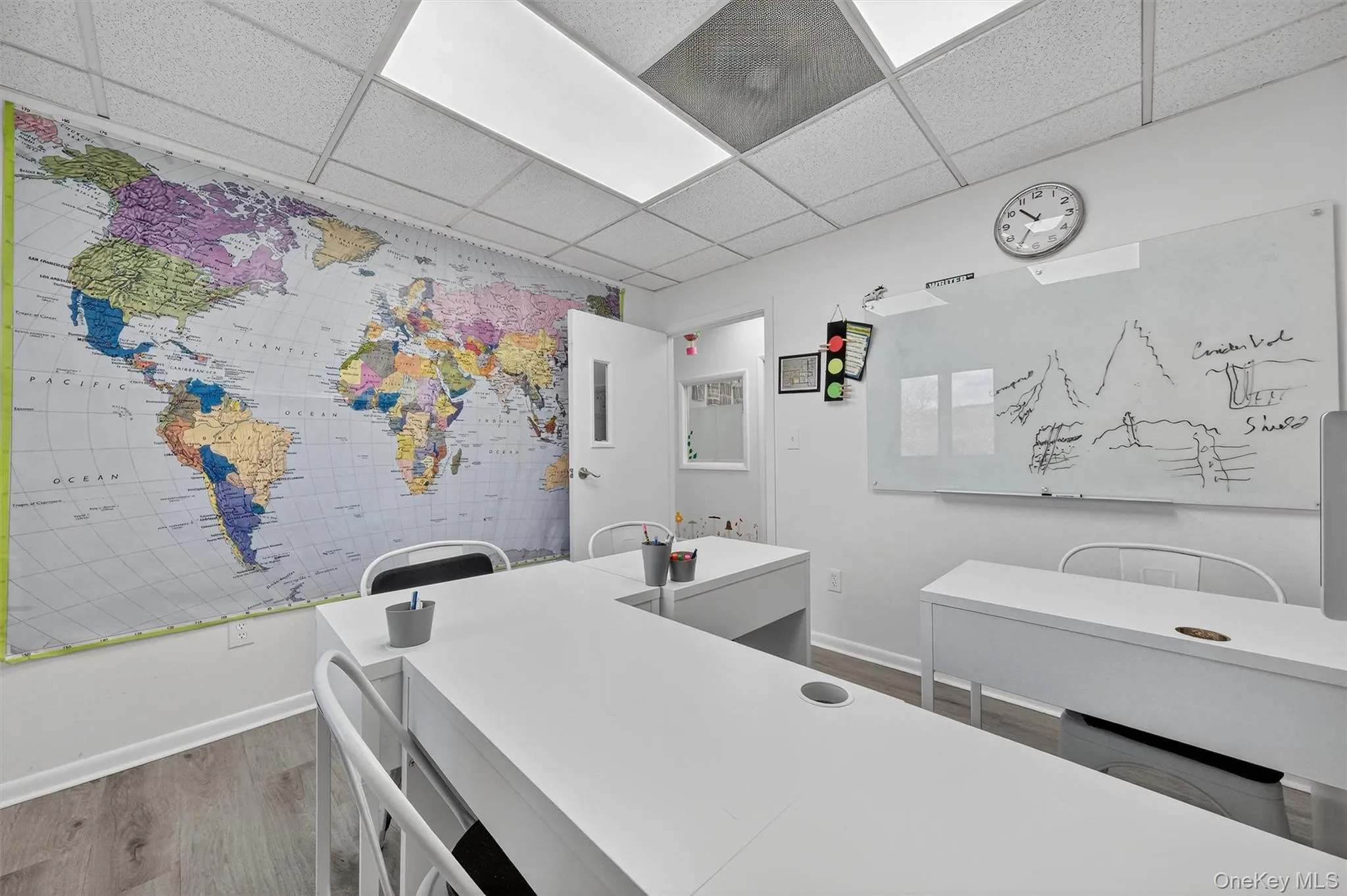 Washroom featuring wood finished floors, a drop ceiling, and an office area Washroom featuring wood finished floors, a drop ceiling, and an office area
