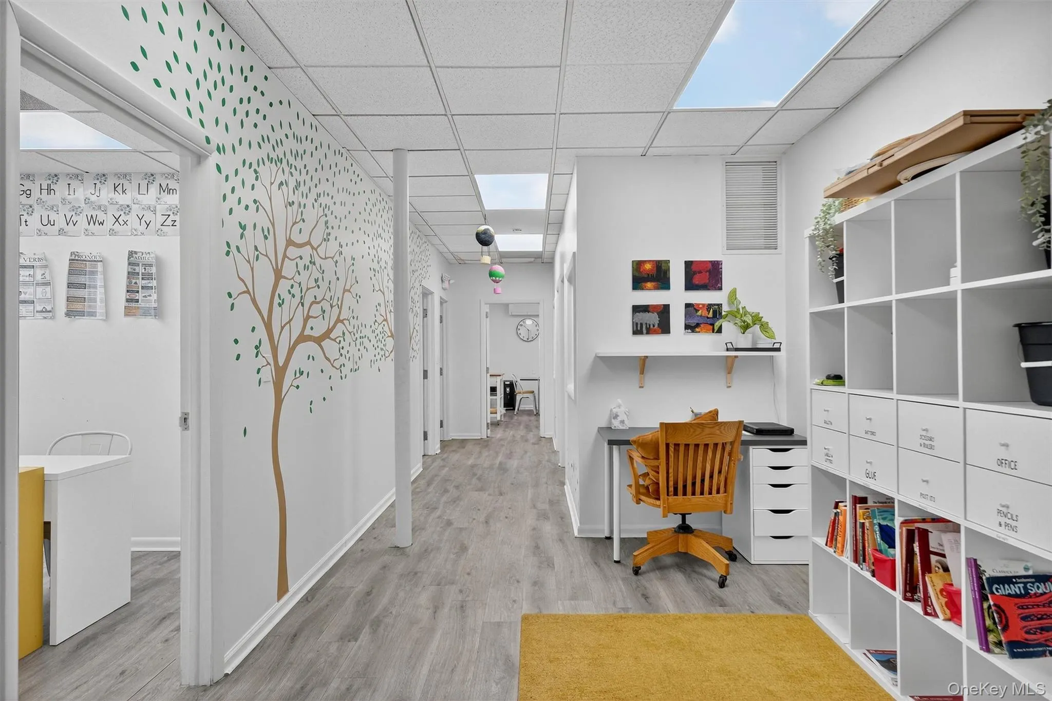 Reception area with a paneled ceiling and light wood-type flooring Reception area with a paneled ceiling and light wood-type flooring