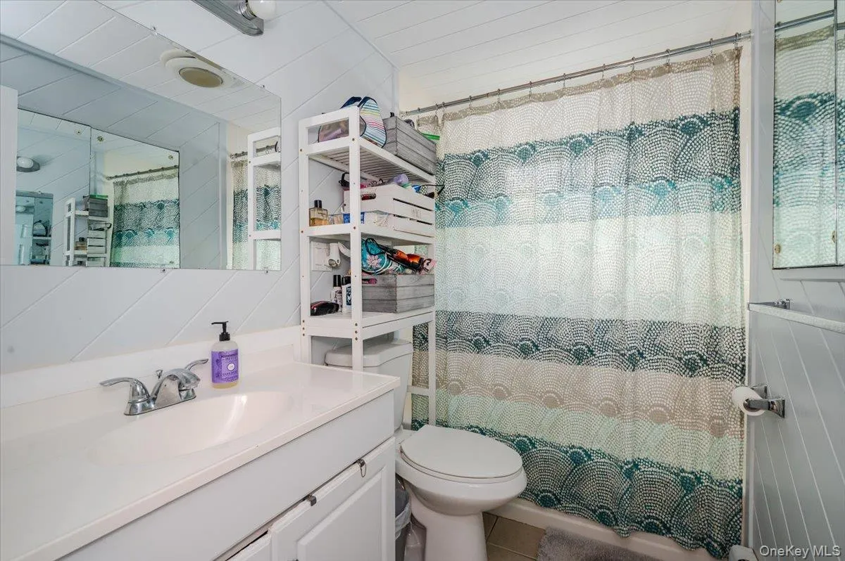 Bathroom with vanity and a shower with curtain Bathroom with vanity and a shower with curtain