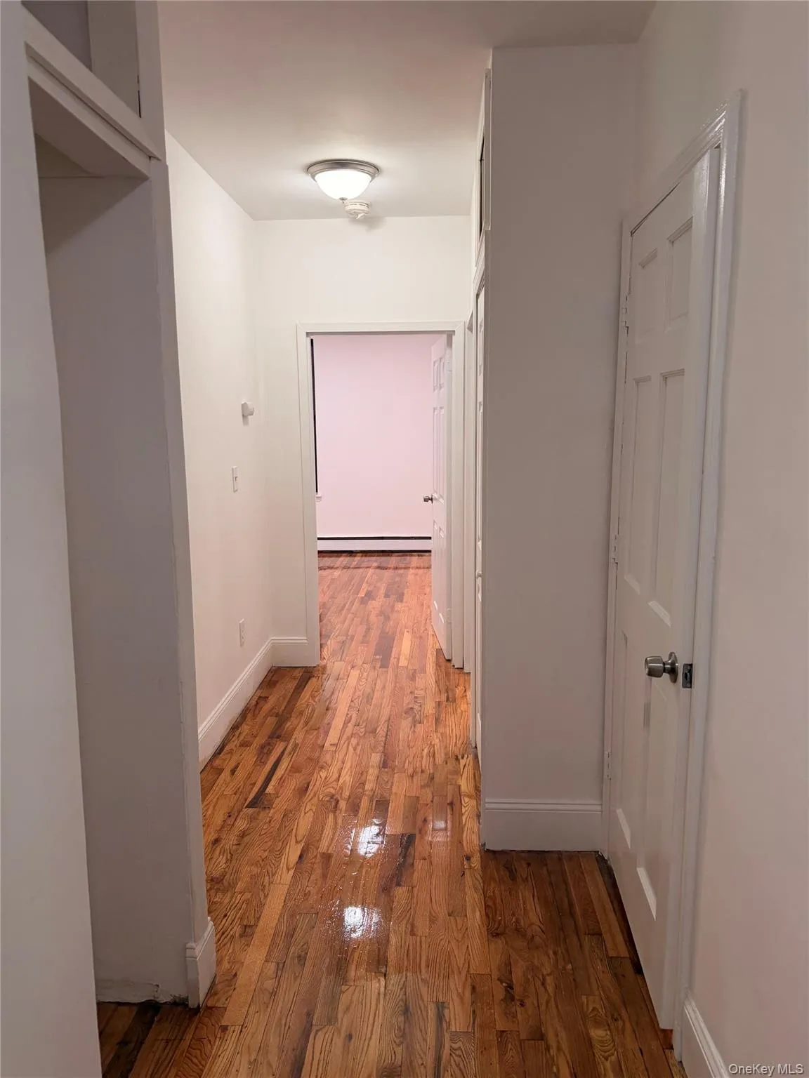 Hallway with light wood-style floors and baseboards Hallway with light wood-style floors and baseboards