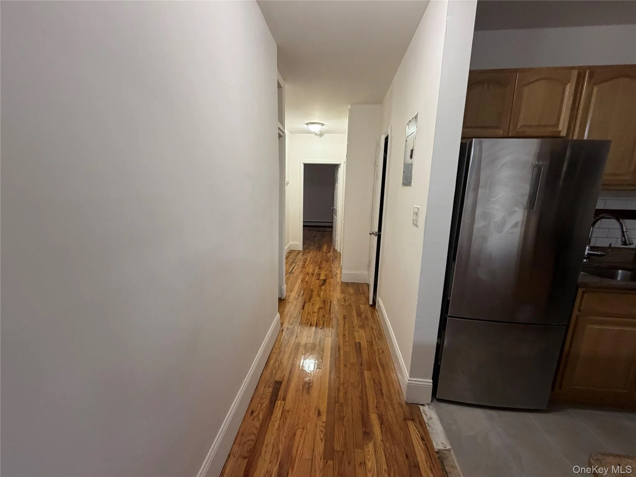 Hall featuring light wood finished floors and baseboards Hall featuring light wood finished floors and baseboards