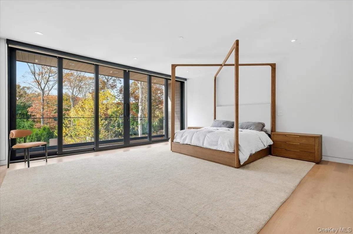 Bedroom featuring floor to ceiling windows, light wood-style flooring, access to exterior, and recessed lighting