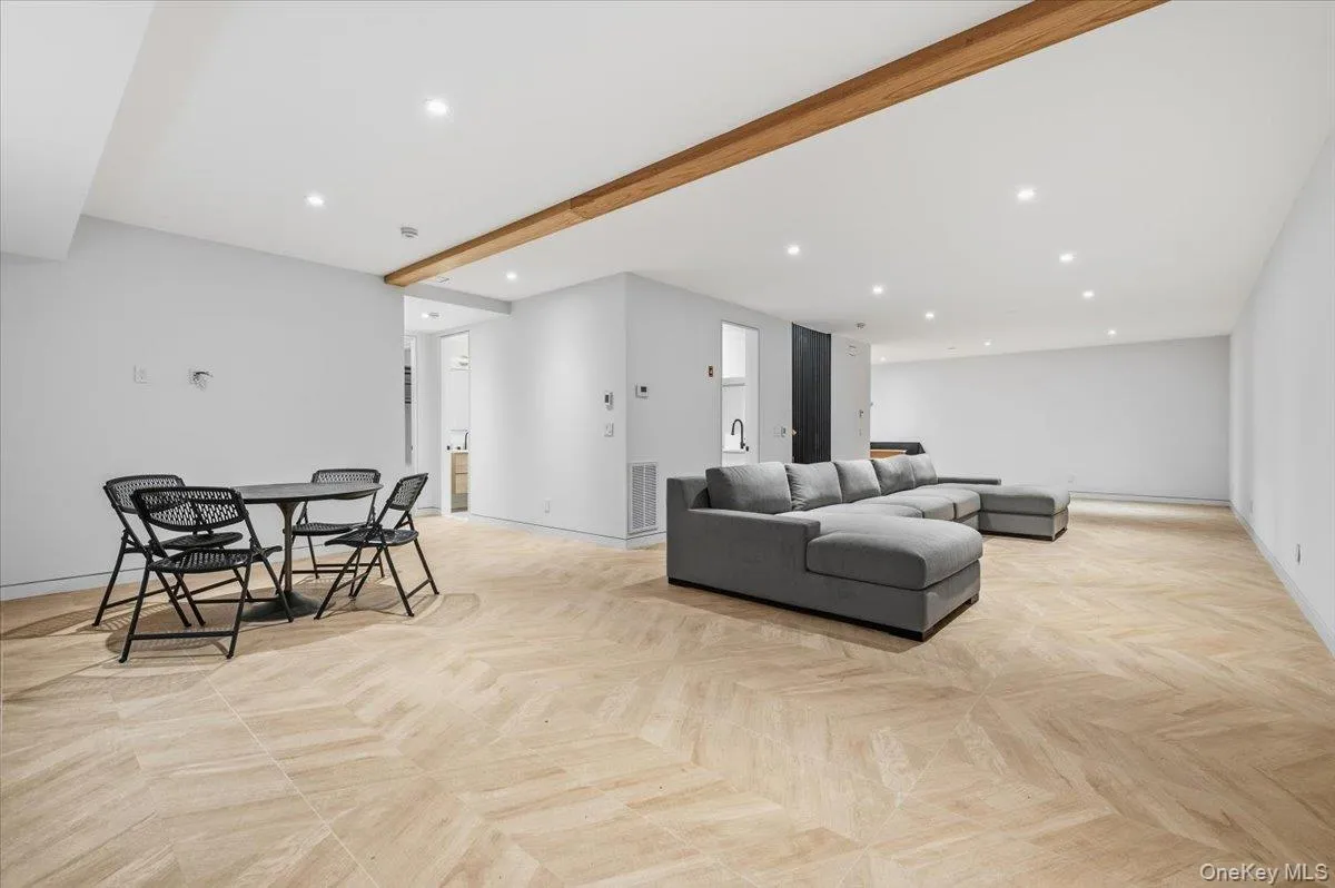 Living room with recessed lighting and beamed ceiling