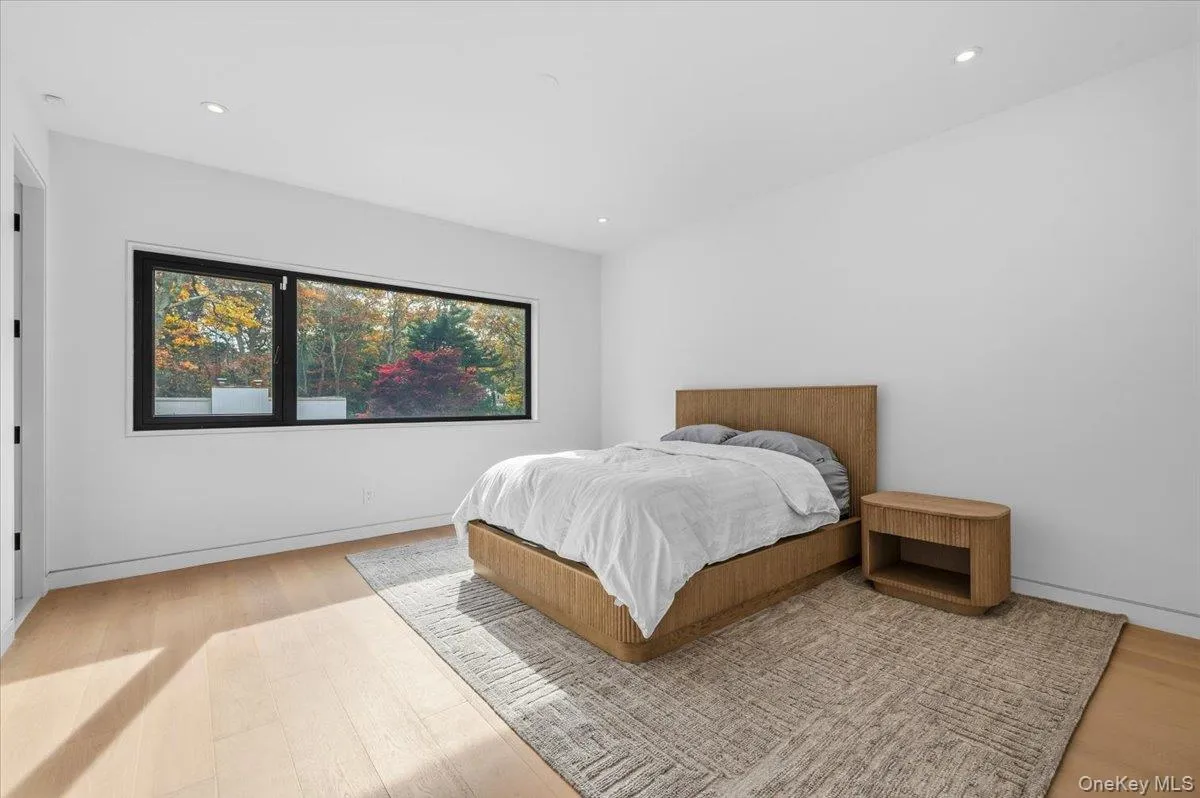 Bedroom with wood finished floors and recessed lighting