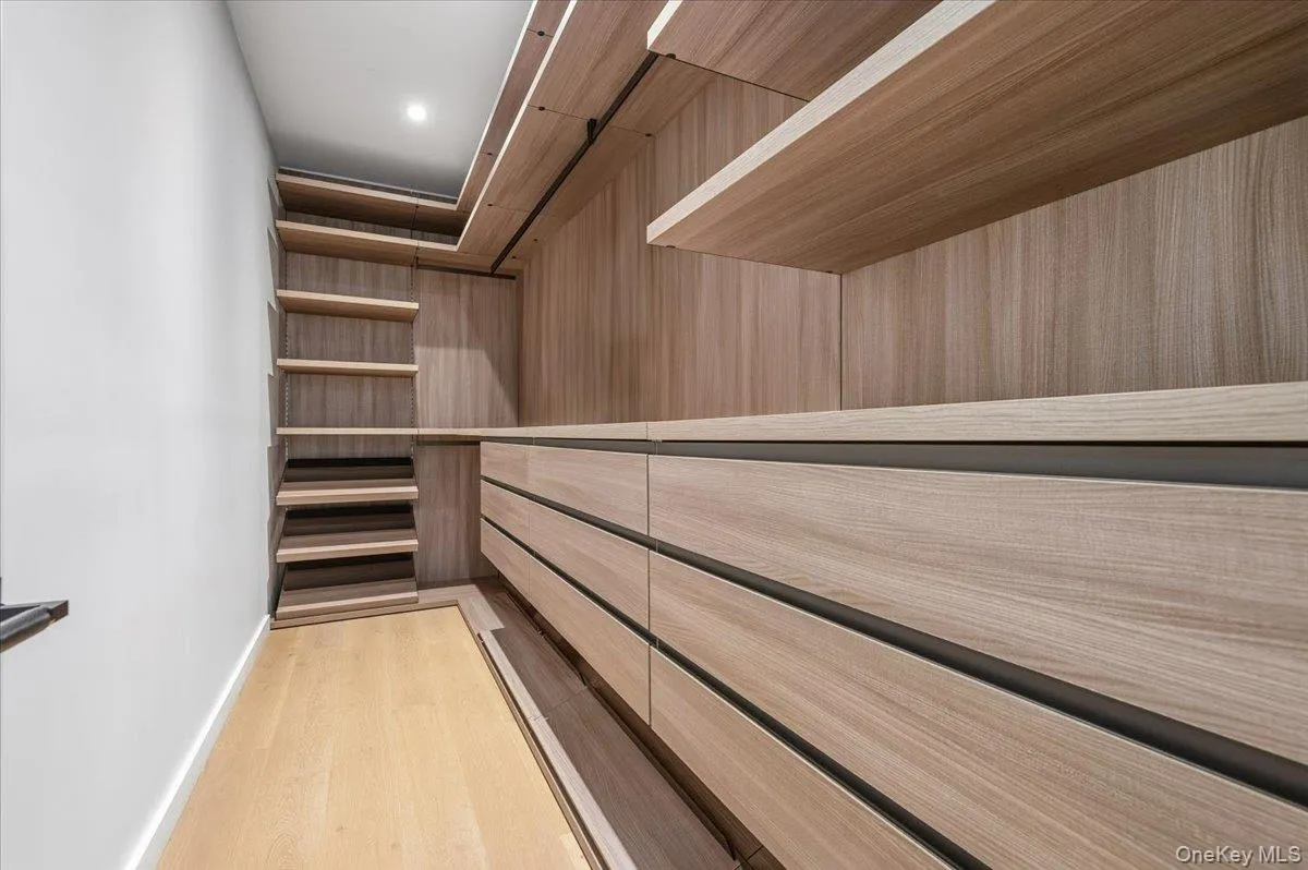 Walk in closet featuring light wood-type flooring