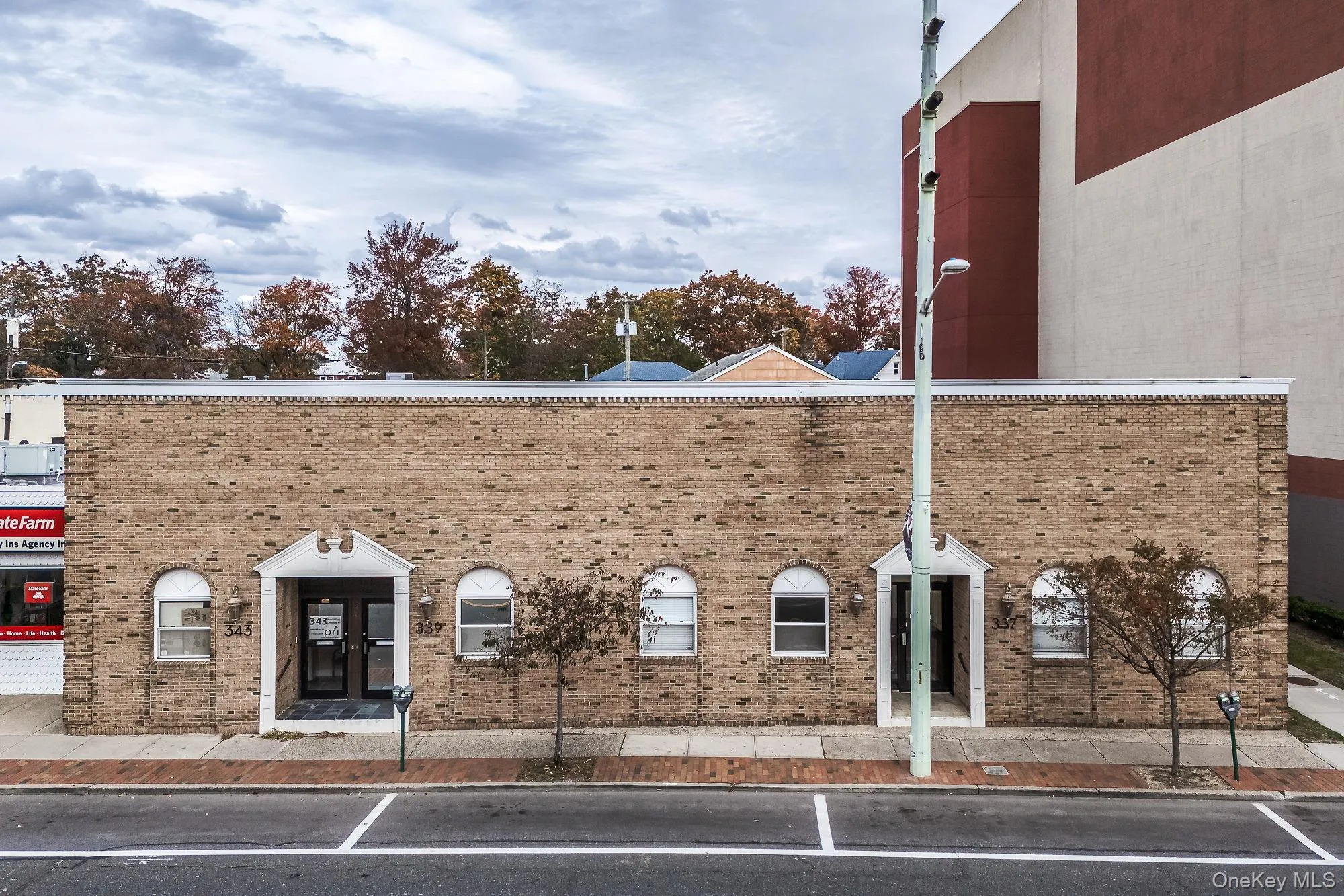 View of building exterior with uncovered parking View of building exterior with uncovered parking