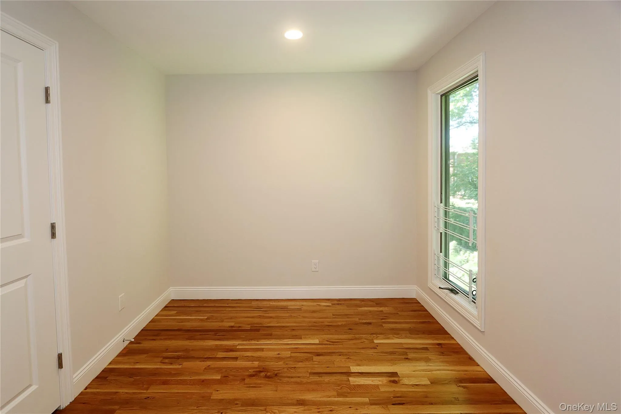Spare room with wood finished floors and recessed lighting Spare room with wood finished floors and recessed lighting