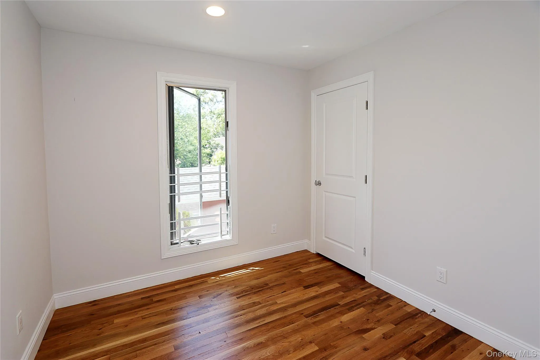 Unfurnished room featuring wood finished floors and recessed lighting Unfurnished room featuring wood finished floors and recessed lighting