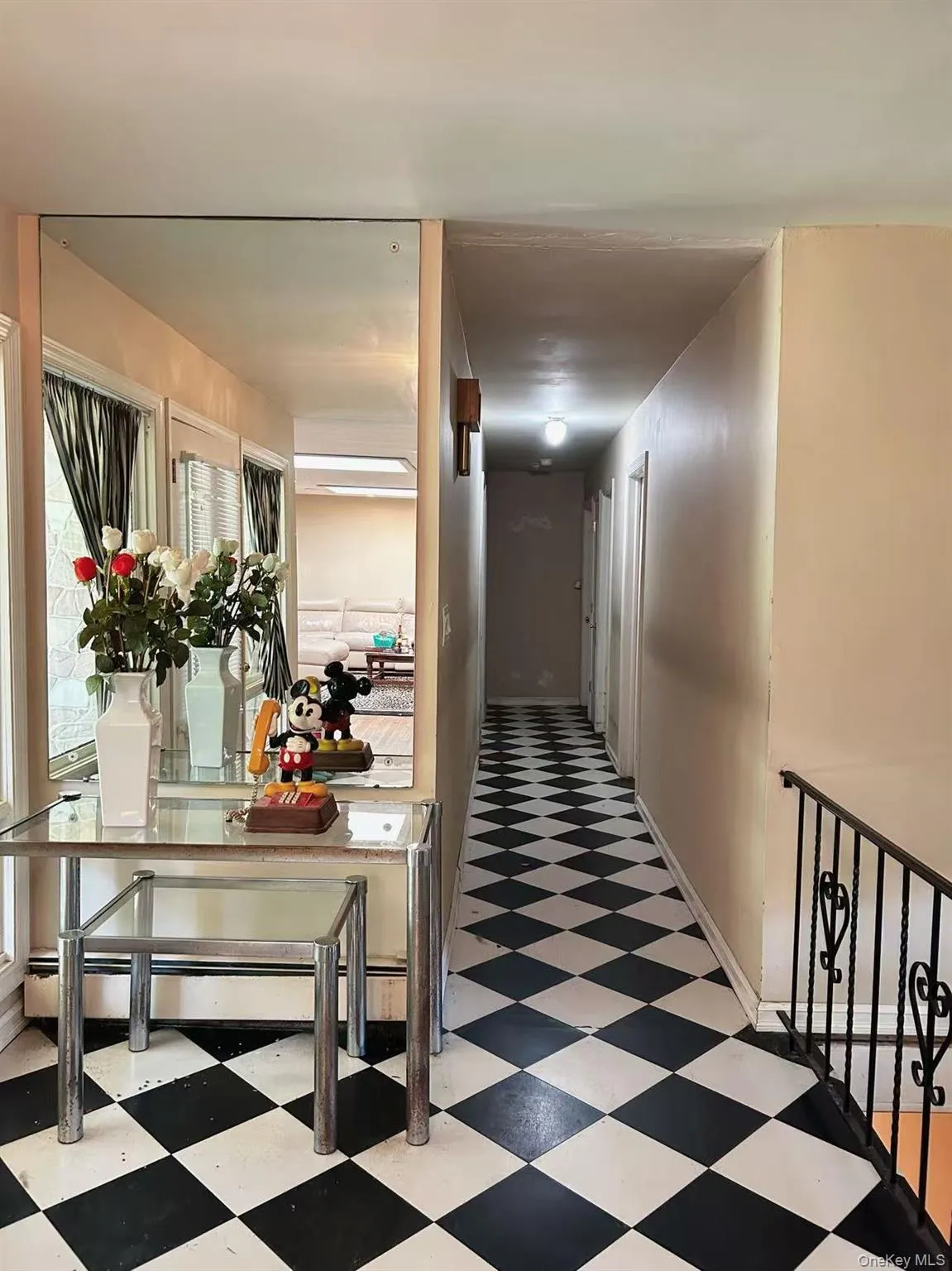 Hall featuring light floors and baseboards Hall featuring light floors and baseboards