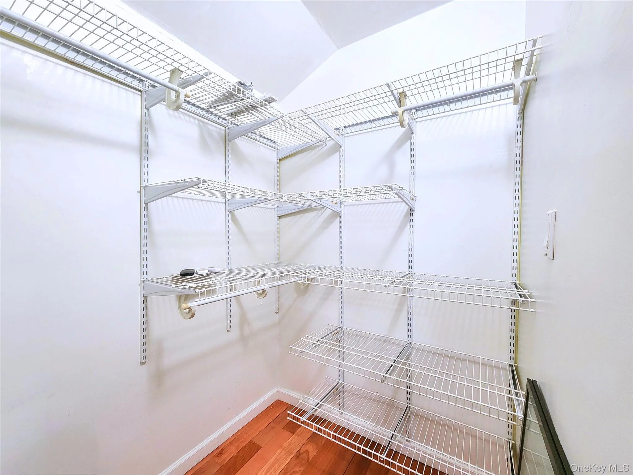 Walk in closet featuring light wood-style floors Walk in closet featuring light wood-style floors