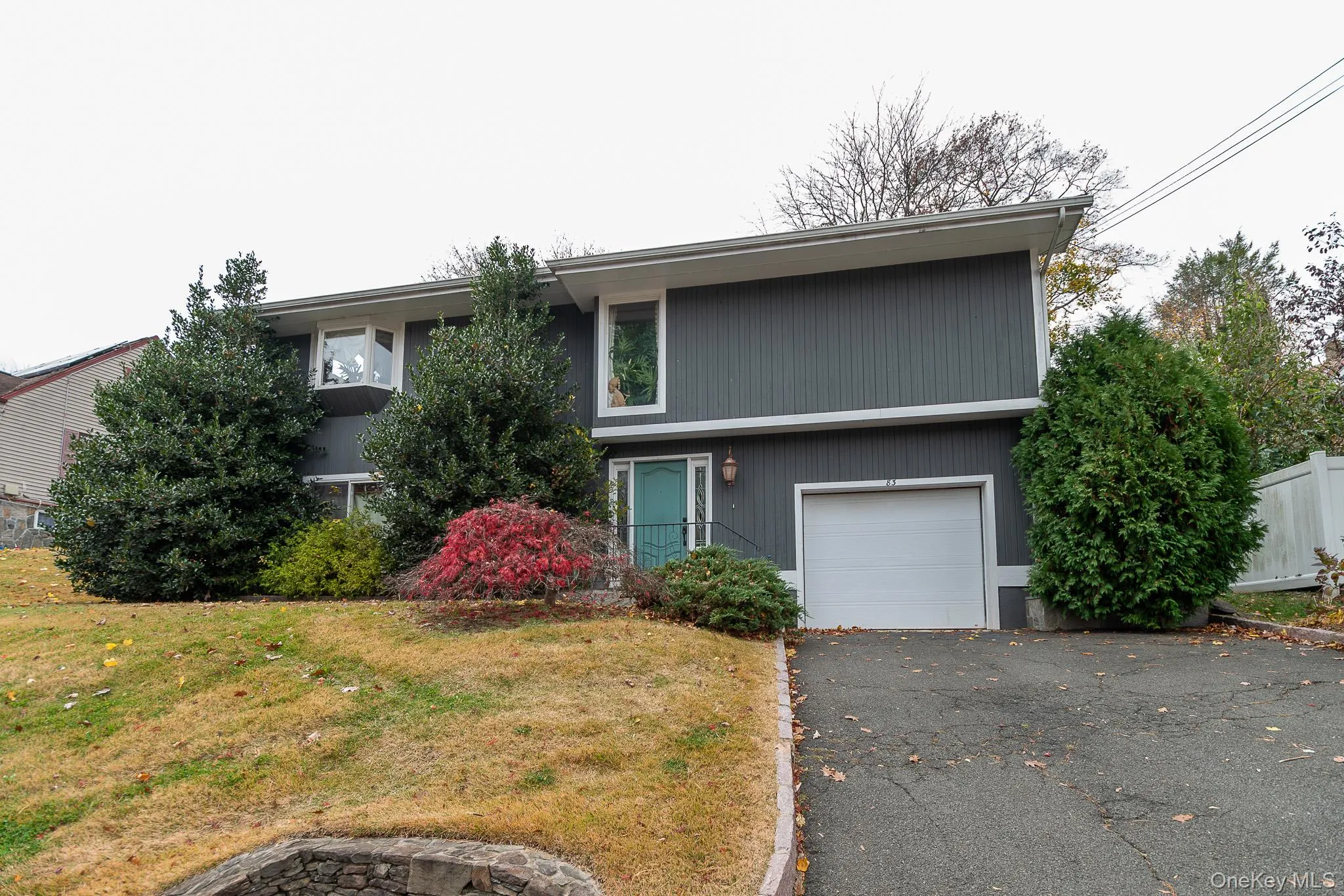 View of front facade with a garage and driveway View of front facade with a garage and driveway