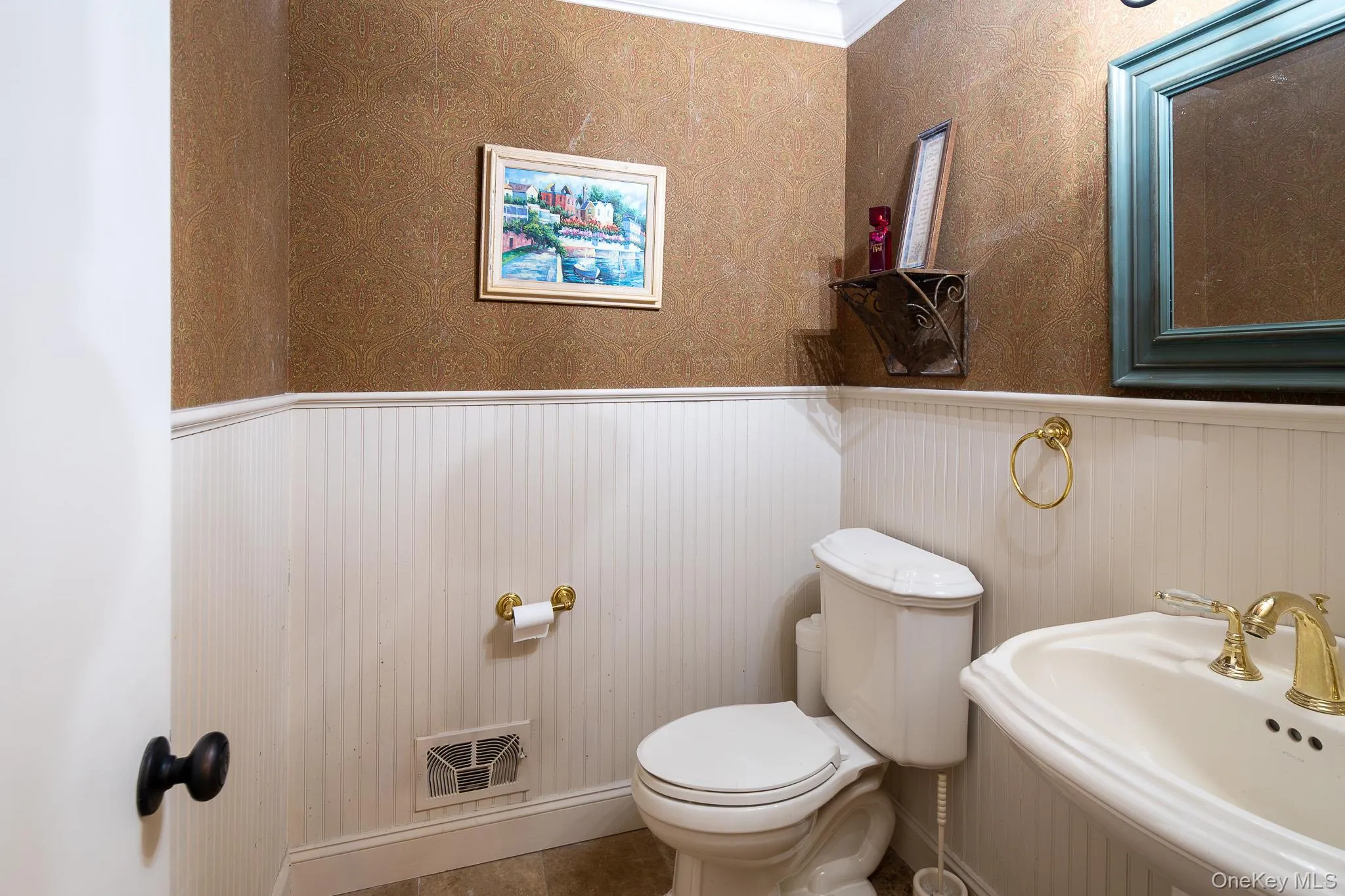 Bathroom with a wainscoted wall, wallpapered walls, and ornamental molding Bathroom with a wainscoted wall, wallpapered walls, and ornamental molding