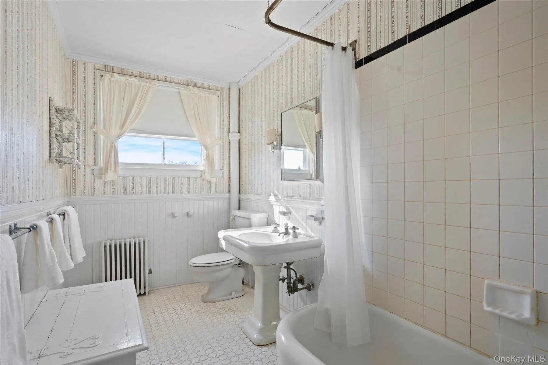 Bathroom featuring crown molding, toilet, and shower / bath combination Bathroom featuring crown molding, toilet, and shower / bath combination