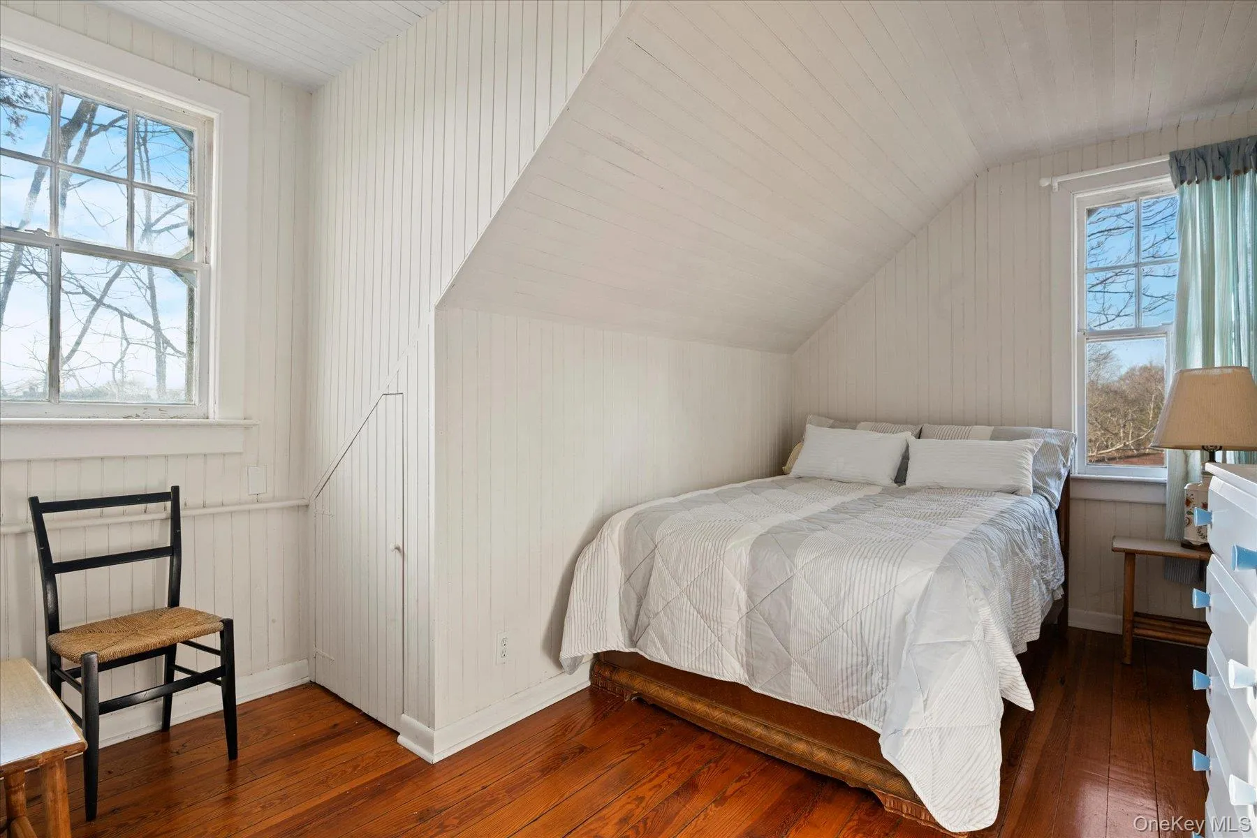 Guest Apt. Bedroom featuring vaulted ceiling and hardwood flooring Guest Apt. Bedroom featuring vaulted ceiling and hardwood flooring