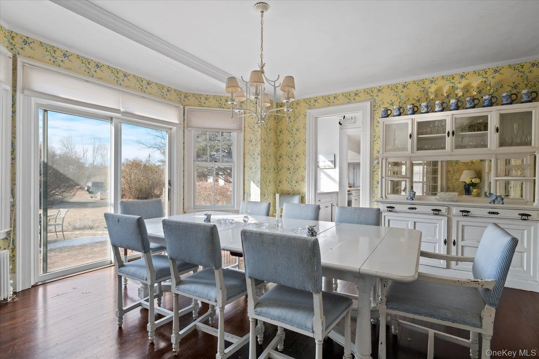 Dining room featuring an inviting chandelier and dark hardwood flooring Dining room featuring an inviting chandelier and dark hardwood flooring