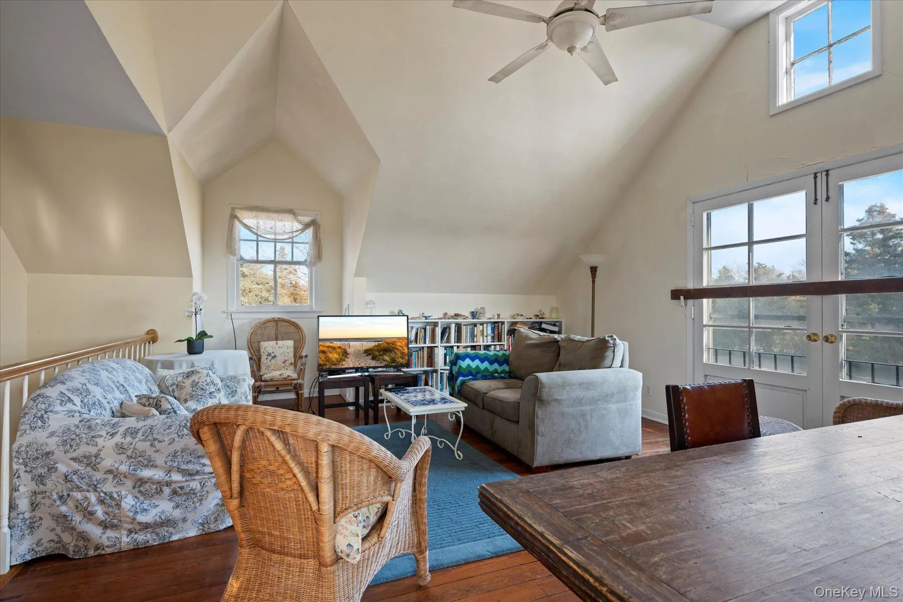 Guest Apt. Great Room featuring lofted ceiling, plenty of natural light, and french doors Guest Apt. Great Room featuring lofted ceiling, plenty of natural light, and french doors