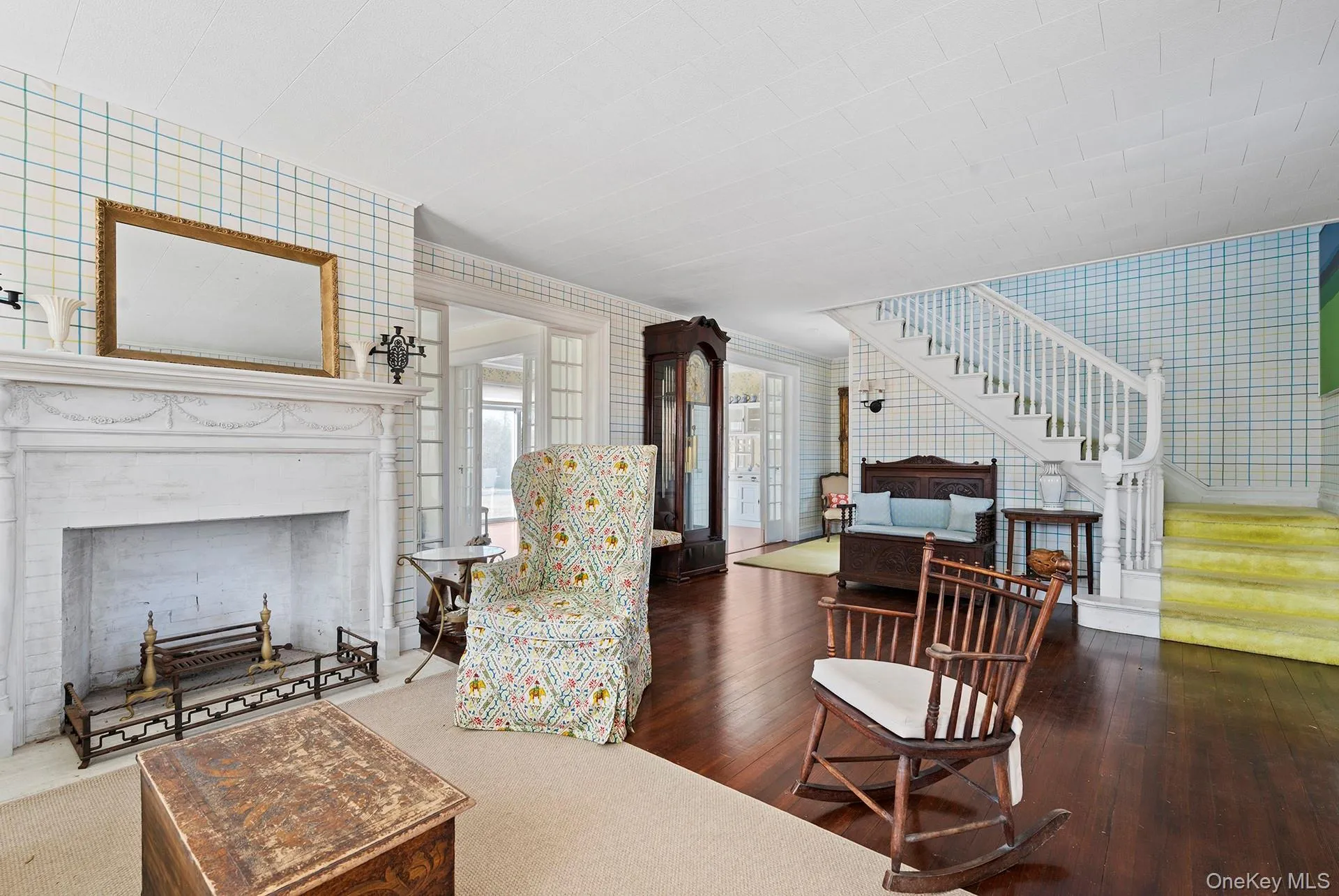 Sitting Room with Fireplace and Foyer with Stairs to Second Floor Sitting Room with Fireplace and Foyer with Stairs to Second Floor