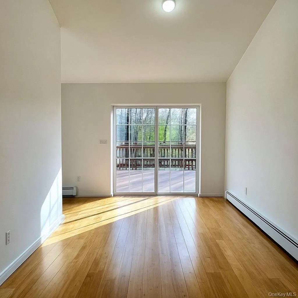 Dining area featuring a baseboard heating unit and light wood-type flooring Dining area featuring a baseboard heating unit and light wood-type flooring